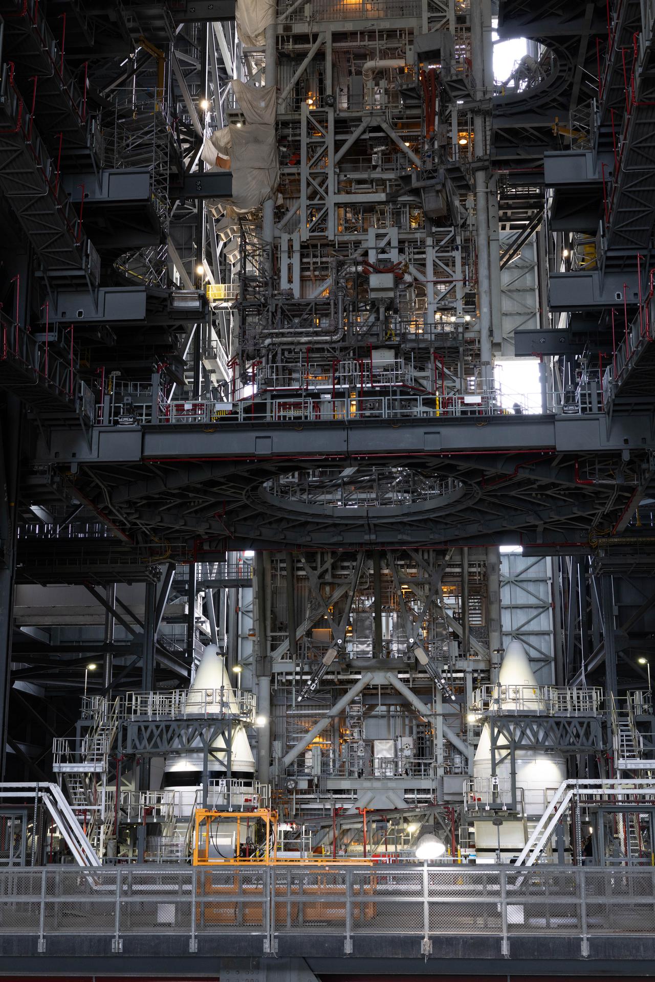 Engineers with NASA’s Exploration Ground Systems completed integrating the aerodynamic nose cones onto the left and right forward assemblies on the twin SLS (Space Launch System) solid rocket boosters, finishing their stacking operations for Artemis III inside the Vehicle Assembly Building’s High Bay 3 at NASA’s Kennedy Space Center in Florida on Wednesday, Sept. 30, 2026. Each forward assembly contains an aerodynamic top, a forward skirt housing avionics, and frustum housing motors that allow the boosters to separate from the SLS core stage after launch. The twin solid boosters will help support the remaining rocket components and the Orion spacecraft during final assembly of the Artemis III rocket and provide more than 75 percent of the total SLS thrust during liftoff from NASA Kennedy’s Launch Pad 39B.