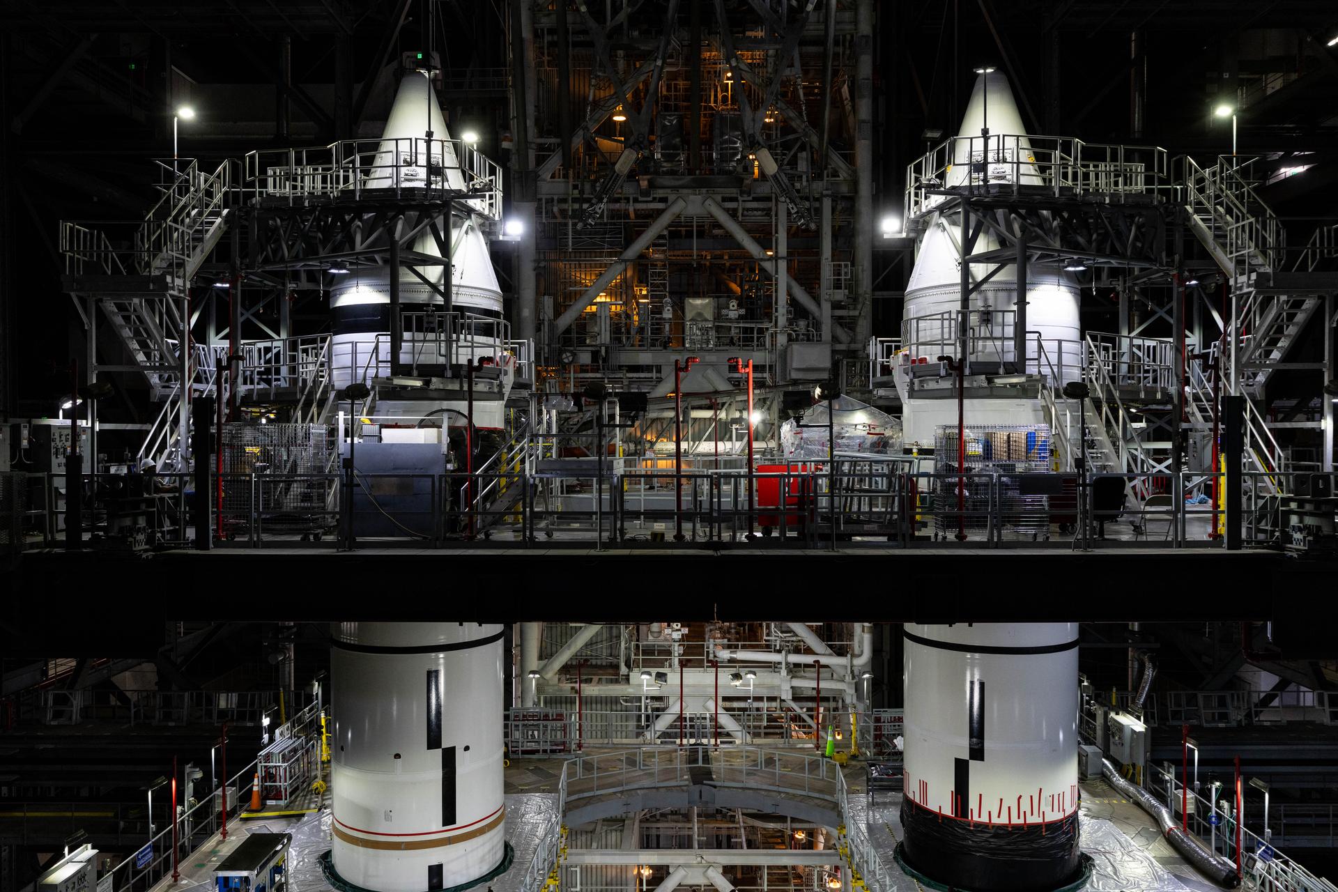 Engineers with NASA’s Exploration Ground Systems complete integration of the aerodynamic nose cones onto the left and right forward segments on the twin SLS (Space Launch System) solid rocket boosters, finishing their stacking operations for Artemis III inside the Vehicle Assembly Building’s High Bay 3 at NASA’s Kennedy Space Center in Florida on Wednesday, Sept. 30, 2026. Each forward assembly contains an aerodynamic top, a forward skirt housing avionics, and frustum housing motors that allow the boosters to separate from the SLS core stage after launch. The twin solid boosters will help support the remaining rocket components and the Orion spacecraft during final assembly of the Artemis III rocket and provide more than 75 percent of the total SLS thrust during liftoff from NASA Kennedy’s Launch Pad 39B.