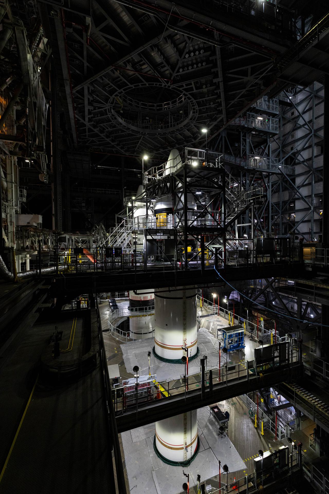 Engineers with NASA’s Exploration Ground Systems complete integration of the aerodynamic nose cones onto the left and right forward segments on the twin SLS (Space Launch System) solid rocket boosters, finishing their stacking operations for Artemis III inside the Vehicle Assembly Building’s High Bay 3 at NASA’s Kennedy Space Center in Florida on Wednesday, Sept. 30, 2026. Each forward assembly contains an aerodynamic top, a forward skirt housing avionics, and frustum housing motors that allow the boosters to separate from the SLS core stage after launch. The twin solid boosters will help support the remaining rocket components and the Orion spacecraft during final assembly of the Artemis III rocket and provide more than 75 percent of the total SLS thrust during liftoff from NASA Kennedy’s Launch Pad 39B.