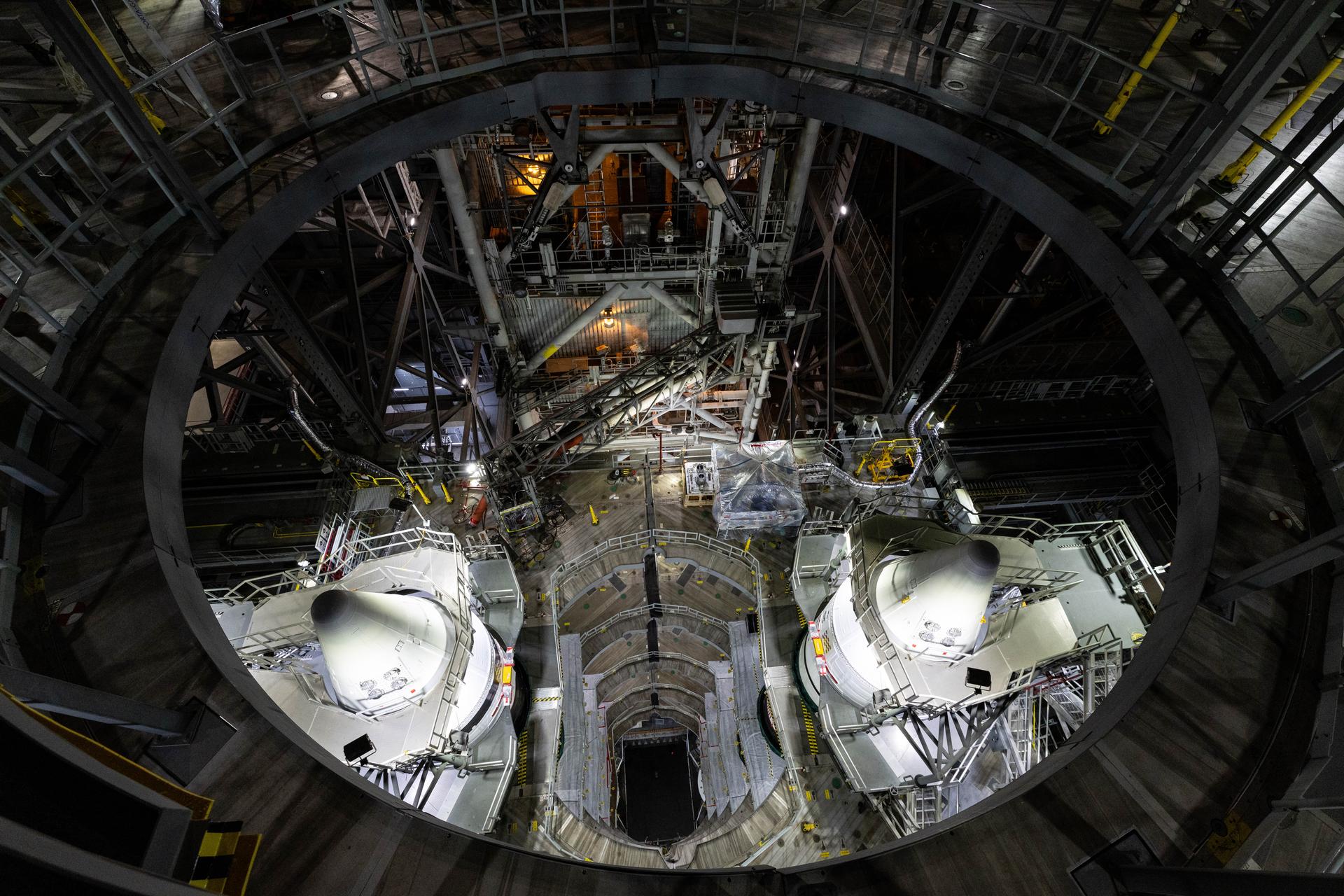 Engineers with NASA’s Exploration Ground Systems complete integration of the aerodynamic nose cones onto the left and right forward segments on the twin SLS (Space Launch System) solid rocket boosters, finishing their stacking operations for Artemis III inside the Vehicle Assembly Building’s High Bay 3 at NASA’s Kennedy Space Center in Florida on Wednesday, Sept. 30, 2026. Each forward assembly contains an aerodynamic top, a forward skirt housing avionics, and frustum housing motors that allow the boosters to separate from the SLS core stage after launch. The twin solid boosters will help support the remaining rocket components and the Orion spacecraft during final assembly of the Artemis III rocket and provide more than 75 percent of the total SLS thrust during liftoff from NASA Kennedy’s Launch Pad 39B.