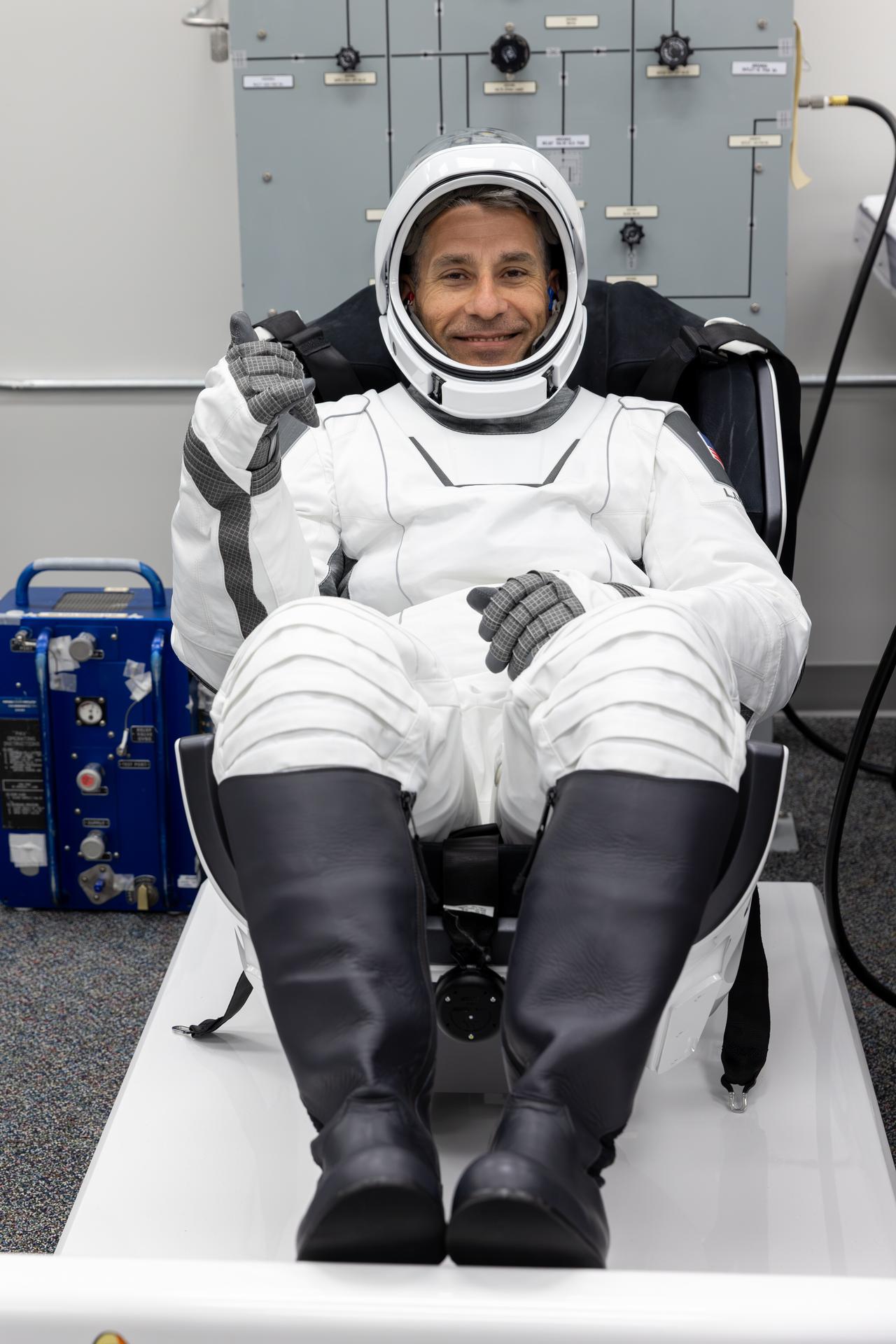 NASA astronaut Luke Delaney smiles during leak checks for his SpaceX spacesuit inside the crew suit-up room in the Neil A. Armstrong Operations and Checkout Building at the agency’s Kennedy Space Center in Florida ahead of launch of NASA’s SpaceX Crew-13 mission to the International Space Station on Thursday, Oct. 1, 2026. Delaney and fellow NASA astronaut Jesssica Watkins, along with CSA (Canadian Space Agency) astronaut Joshua Kutryk, and Roscosmos cosmonaut Sergey Teteryatnikov are scheduled to lift off aboard SpaceX’s Dragon spacecraft and Falcon 9 rocket no earlier than 11:10 a.m. EDT, from Space Launch Complex 40 at Cape Canaveral Space Force Station in Florida.