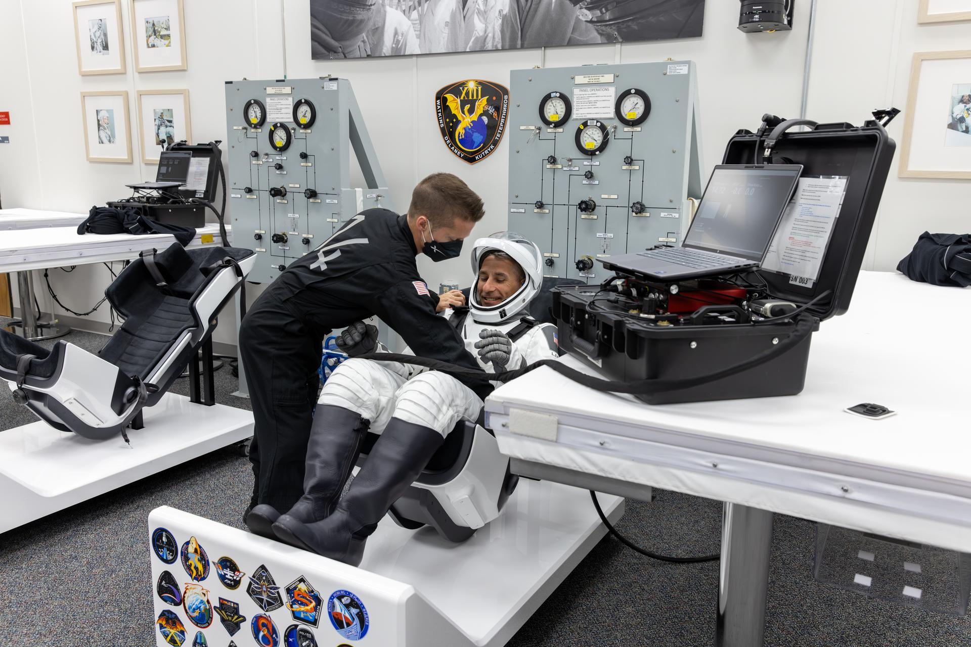 NASA astronaut Luke Delaney smiles during leak checks for his SpaceX spacesuit inside the crew suit-up room in the Neil A. Armstrong Operations and Checkout Building at the agency’s Kennedy Space Center in Florida ahead of launch of NASA’s SpaceX Crew-13 mission to the International Space Station on Thursday, Oct. 1, 2026. Delaney and fellow NASA astronaut Jesssica Watkins, along with CSA (Canadian Space Agency) astronaut Joshua Kutryk, and Roscosmos cosmonaut Sergey Teteryatnikov are scheduled to lift off aboard SpaceX’s Dragon spacecraft and Falcon 9 rocket no earlier than 11:10 a.m. EDT, from Space Launch Complex 40 at Cape Canaveral Space Force Station in Florida.