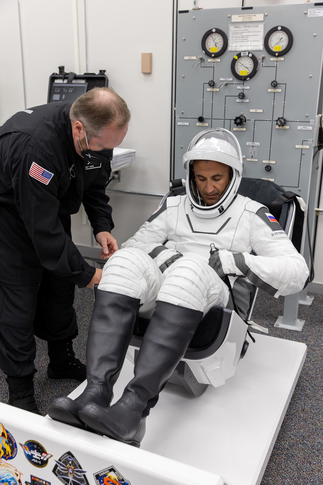 Roscosmos cosmonaut Sergey Teteryatnikov conducts leak checks for his SpaceX spacesuit inside the crew suit-up room in the Neil A. Armstrong Operations and Checkout Building at the agency’s Kennedy Space Center in Florida ahead of launch of NASA’s SpaceX Crew-13 mission to the International Space Station on Thursday, Oct. 1, 2026. NASA astronauts Jessica Watkins and Luke Delaney, CSA (Canadian Space Agency) astronaut Joshua Kutryk, and Teteryatnikov are scheduled to lift off aboard SpaceX’s Dragon spacecraft and Falcon 9 rocket no earlier than 11:10 a.m. EDT, from Space Launch Complex 40 at Cape Canaveral Space Force Station in Florida.