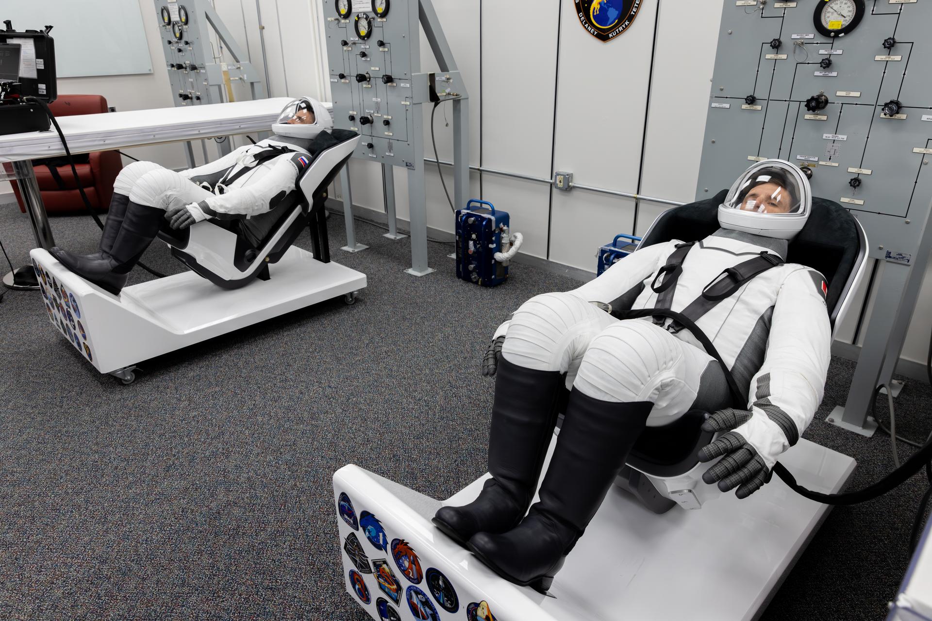 From left to right, Roscosmos cosmonaut Sergey Teteryatnikov and CSA (Canadian Space Agency) astronaut Joshua Kutryk conduct leak checks for their SpaceX spacesuits inside the crew suit-up room in the Neil A. Armstrong Operations and Checkout Building at the agency’s Kennedy Space Center in Florida ahead of launch of NASA’s SpaceX Crew-13 mission to the International Space Station on Thursday, Oct. 1, 2026. Kutryk and Teteryatnikov and NASA astronauts Jessica Watkins and Luke Delaney are scheduled to lift off aboard SpaceX’s Dragon spacecraft and Falcon 9 rocket no earlier than 11:10 a.m. EDT, from Space Launch Complex 40 at Cape Canaveral Space Force Station in Florida.