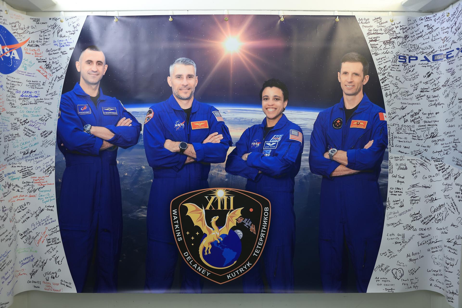 Dozens of signatures and well-wishes are written on NASA’s SpaceX Crew-13 banner inside the Astronaut Crew Quarters inside Neil A. Armstrong Operations and Checkout Building at the agency’s Kennedy Space Center in Florida ahead of launch on Thursday, Oct. 1, 2026. NASA astronauts Jessica Watkins and Luke Delaney, along with CSA (Canadian Space Agency) astronaut Joshua Kutryk, and Roscosmos cosmonaut Sergey Teteryatnikov are scheduled to lift off aboard SpaceX’s Dragon spacecraft and Falcon 9 rocket no earlier than 11:10 a.m. EDT, from Space Launch Complex 40 at Cape Canaveral Space Force Station in Florida.