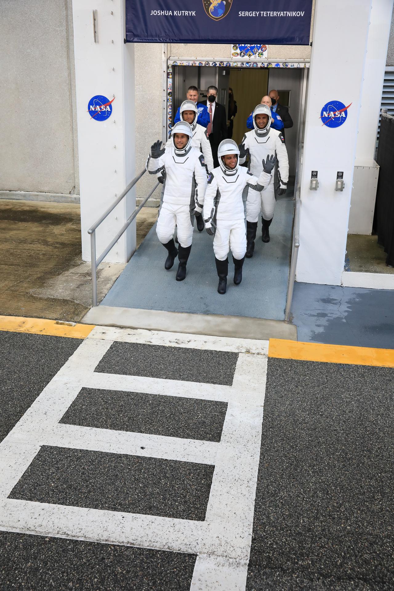 From left to right, NASA astronauts Luke Delaney and Jessica Watkins (front), and CSA (Canadian Space Agency) astronaut Joshua Kutryk, along with Roscosmos cosmonaut Sergey Teteryatnikov (back), wave to family and friends as they prepare to depart the Neil A. Armstrong Operations and Checkout Building at the agency’s Kennedy Space Center in Florida for nearby Space Launch Complex 40 at Cape Canaveral Space Force Station for launch of Crew-13 on Thursday, Oct. 1, 2026. Crew-13 is scheduled to lift off aboard SpaceX’s Dragon spacecraft and Falcon 9 rocket no earlier than 11:10 a.m. EDT, from Space Launch Complex 40 at Cape Canaveral Space Force Station in Florida.