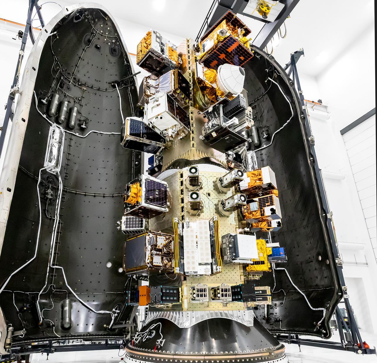 Three NASA-supported small spacecraft, shown along with many commercial payloads, before being encapsulated in a SpaceX Falcon 9. The rocket launched the payloads into low-Earth orbit at 11:32 a.m. PDT Thursday, Oct. 1, 2026, as part of the company’s Transporter-18 mission from Space Launch Complex 4 East at Vandenberg Space Force Base in California. The ASCENT Propulsion Dual Mode CubeSat, the Supernova Remnants and Proxies for ReIonization Testbed Experiment (SPRITE) CubeSat, and the Small Spacecraft Propulsion and Inspection Capability (SSPICY) mission will demonstrate new propulsion technologies, study how galactic dust and high-energy radiation move through galaxies, and advance capabilities for inspecting inactive satellites.