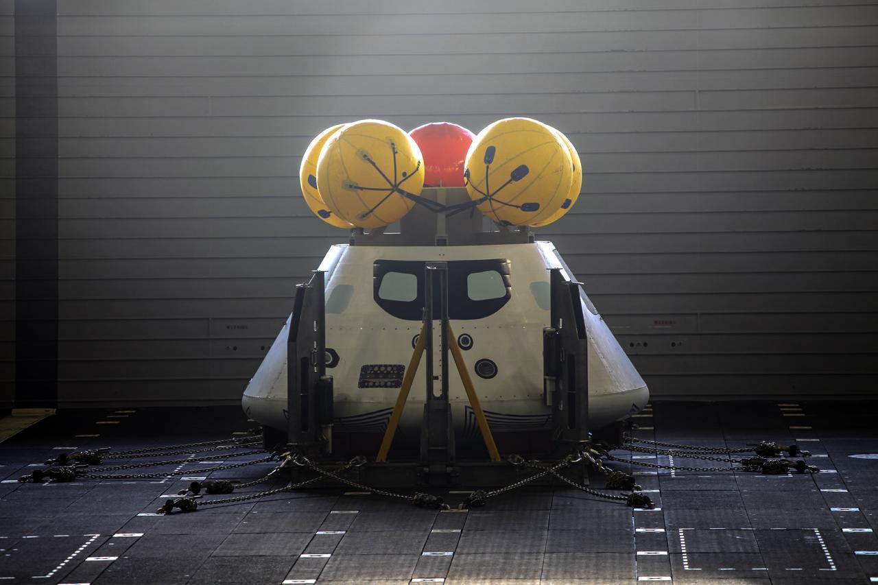 HAMPTON, Va. – At the Naval Station Norfolk near NASA’s Langley Research Center in Virginia, the Orion boilerplate test article is being prepared for a stationary recovery test on a U.S. Navy ship. NASA and the U.S. Navy are conducting tests to prepare for recovery of the Orion crew module and forward bay cover on its return from a deep space mission. The stationary recovery test will allow the teams to demonstrate and evaluate the recovery processes, procedures, hardware and personnel in a controlled environment before conducting a second recovery test next year in open waters. Orion is the exploration spacecraft designed to carry astronauts to destinations not yet explored by humans, including an asteroid and Mars. It will have emergency abort capability, sustain the crew during space travel and provide safe re-entry from deep space return velocities. The first unpiloted test flight of the Orion is scheduled to launch in 2014 atop a Delta IV rocket and in 2017 on NASA’s Space Launch System rocket. For more information, visit http://www.nasa.gov/orion. Photo credit: NASA/Dimitri Gerondidakis