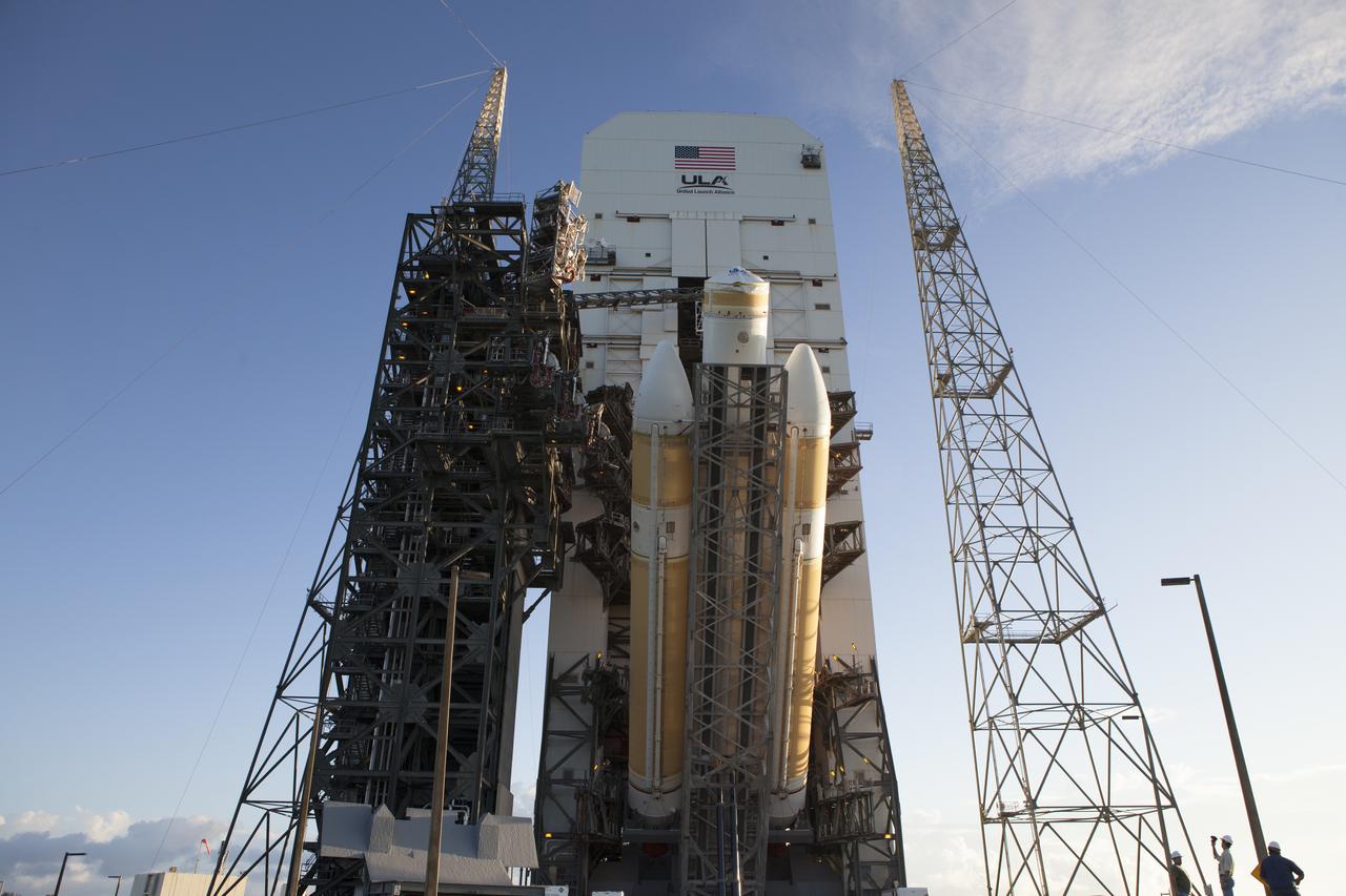 The United Launch Alliance Delta IV Heavy rocket for Exploration Flight Test-1 is lifted to the vertical position in the mobile service tower on the pad at Space Launch Complex 37 at Cape Canaveral Air Force Station in Florida. The Delta IV Heavy is being readied to launch Orion on its first flight test. During its first flight test, Orion will travel farther into space than any human spacecraft has gone in more than 40 years. The data gathered during the flight will influence design decisions, validate existing computer models and innovative new approaches to space systems development, as well as reduce overall mission risks and costs for later Orion flights. Liftoff of Orion on the first flight test is planned for December 2014.