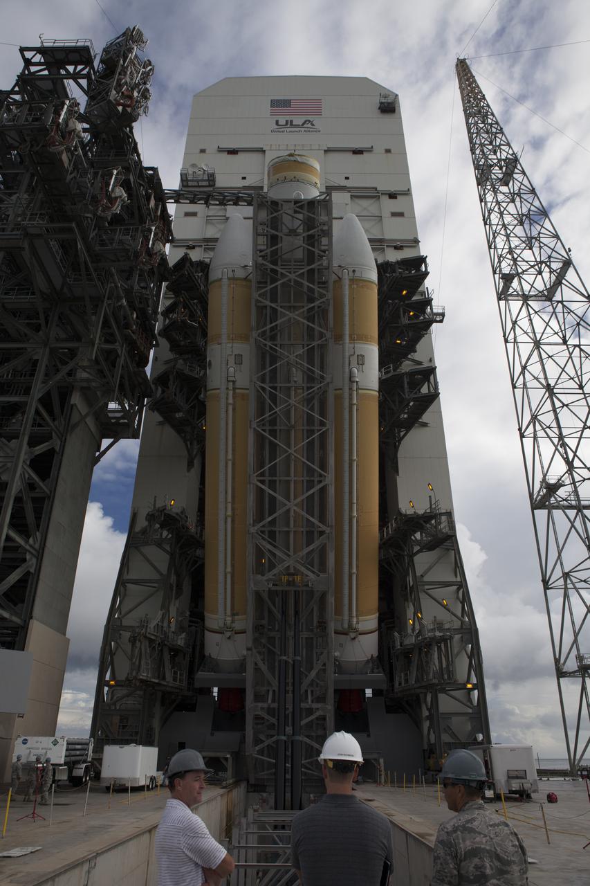 United Launch Alliance, or ULA, workers monitor the progress as the ULA Delta IV Heavy rocket for Exploration Flight Test-1 is lifted to the vertical position in the mobile service tower on the pad at Space Launch Complex 37 at Cape Canaveral Air Force Station in Florida. The Delta IV Heavy is being readied to launch Orion on its first flight test. During its first flight test, Orion will travel farther into space than any human spacecraft has gone in more than 40 years. The data gathered during the flight will influence design decisions, validate existing computer models and innovative new approaches to space systems development, as well as reduce overall mission risks and costs for later Orion flights. Liftoff of Orion on the first flight test is planned for December 2014.