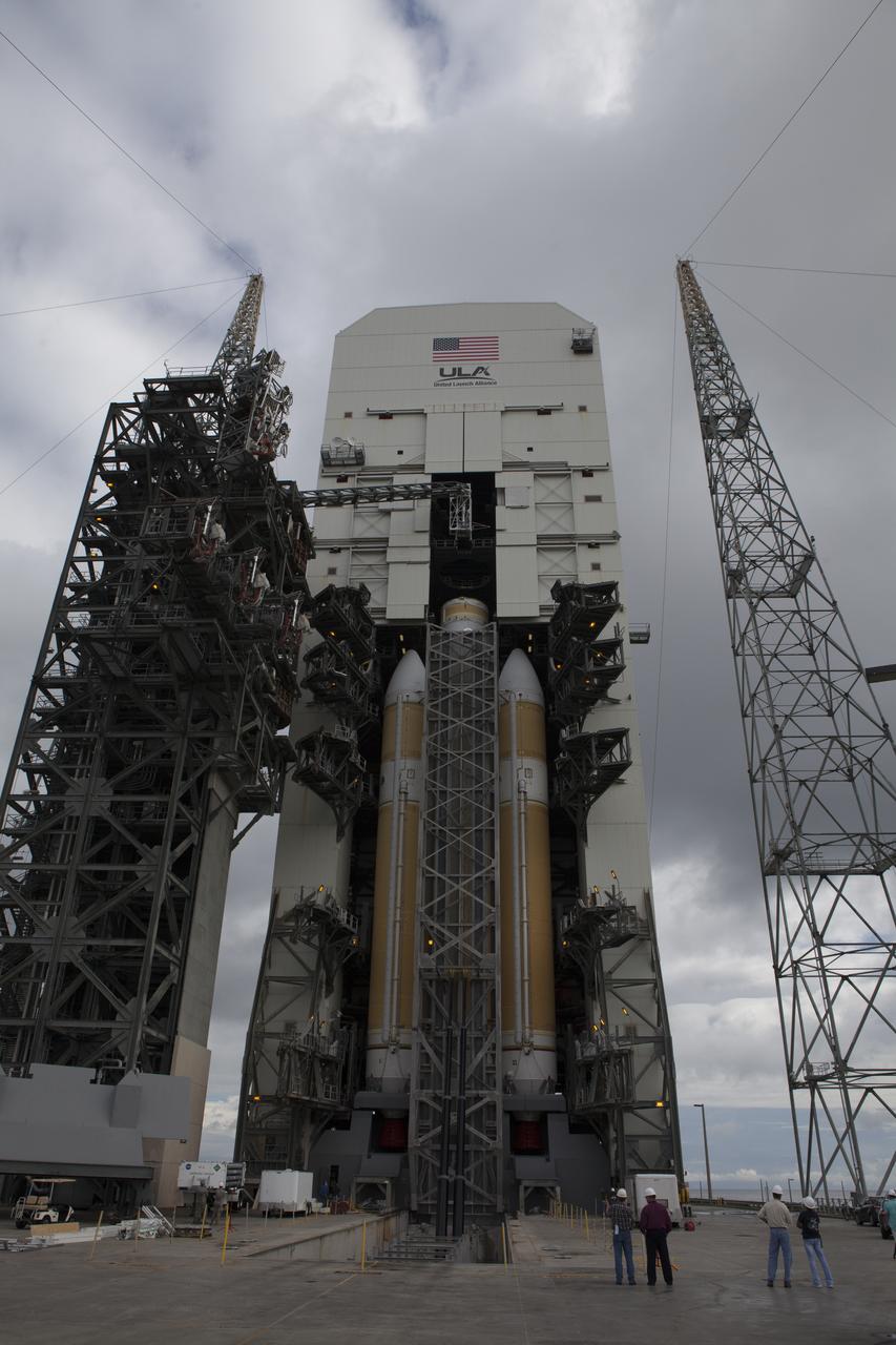 The United Launch Alliance Delta IV Heavy rocket for Exploration Flight Test-1 is lifted to the vertical position in the mobile service tower on the pad at Space Launch Complex 37 at Cape Canaveral Air Force Station in Florida. The Delta IV Heavy is being readied to launch Orion on its first flight test. During its first flight test, Orion will travel farther into space than any human spacecraft has gone in more than 40 years. The data gathered during the flight will influence design decisions, validate existing computer models and innovative new approaches to space systems development, as well as reduce overall mission risks and costs for later Orion flights. Liftoff of Orion on the first flight test is planned for December 2014.