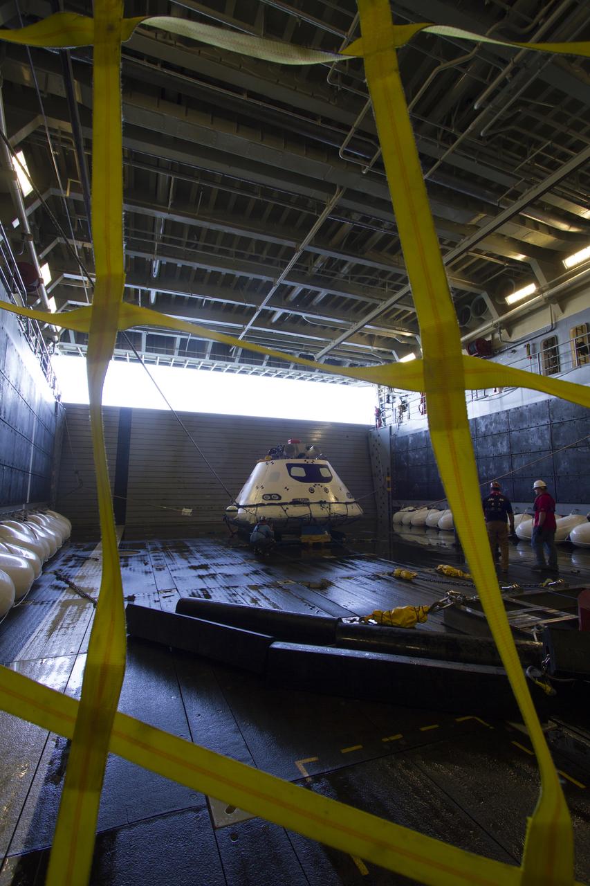 The Orion boilerplate test vehicle is secured in the well deck of the USS Anchorage during the first day of Underway Recovery Test 3 in the Pacific Ocean. NASA, Lockheed Martin and U.S. Navy personnel are conducting the recovery test to prepare for recovery of the Orion crew module on its return from a deep space mission. The test allows the teams to demonstrate and evaluate the recovery processes, procedures, hardware and personnel in open waters. The Ground Systems Development and Operations Program is conducting the underway recovery tests. Orion is the exploration spacecraft designed to carry astronauts to destinations not yet explored by humans, including an asteroid and Mars. It will have emergency abort capability, sustain the crew during space travel and provide safe re-entry from deep space return velocities. The first unpiloted test flight of Orion is scheduled to launch in 2014 atop a United Launch Alliance Delta IV Heavy rocket and in 2018 on NASA’s Space Launch System rocket.
