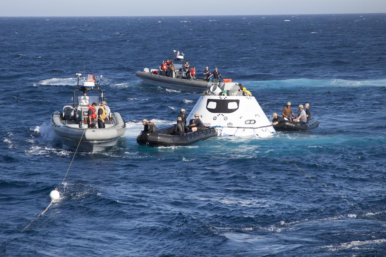 The Orion boilerplate test vehicle floats in the Pacific Ocean near the USS Anchorage during Underway Recovery Test 3. U.S. Navy divers and other recovery team members in two Zodiac boats attach tether lines to Orion. Other recovery team members are nearby in two rigid hull inflatable boats. NASA, Lockheed Martin and U.S. Navy personnel are conducting the recovery test to prepare for recovery of the Orion crew module on its return from a deep space mission. The test allows the teams to demonstrate and evaluate the recovery processes, procedures, hardware and personnel in open waters. The Ground Systems Development and Operations Program is conducting the underway recovery tests. Orion is the exploration spacecraft designed to carry astronauts to destinations not yet explored by humans, including an asteroid and Mars. It will have emergency abort capability, sustain the crew during space travel and provide safe re-entry from deep space return velocities. The first unpiloted test flight of Orion is scheduled to launch in 2014 atop a United Launch Alliance Delta IV Heavy rocket and in 2018 on NASA’s Space Launch System rocket. 