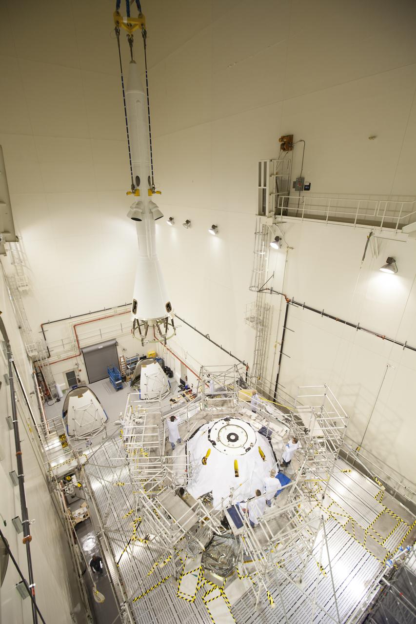 A crane is used to lift and move the launch abort system for installation on the Orion spacecraft for Exploration Flight Test-1 inside the Launch Abort System Facility, or LASF, at NASA's Kennedy Space Center in Florida. The completed crew and service modules will be tested and verified together with the launch abort system. Orion will remain inside the LASF until mid-November, when the United Launch Alliance Delta IV Heavy rocket is ready for integration with the spacecraft. Orion is the exploration spacecraft designed to carry astronauts to destinations not yet explored by humans, including an asteroid and Mars. It will have emergency abort capability, sustain the crew during space travel and provide safe re-entry from deep space return velocities. The first unpiloted test flight of the Orion is scheduled to launch in December atop the Delta IV Heavy rocket from Cape Canaveral Air Force Station in Florida to an altitude of 3,600 miles above the Earth's surface. The two-orbit, four-hour flight test will help engineers evaluate the systems critical to crew safety including the heat shield, parachute system and launch abort system.