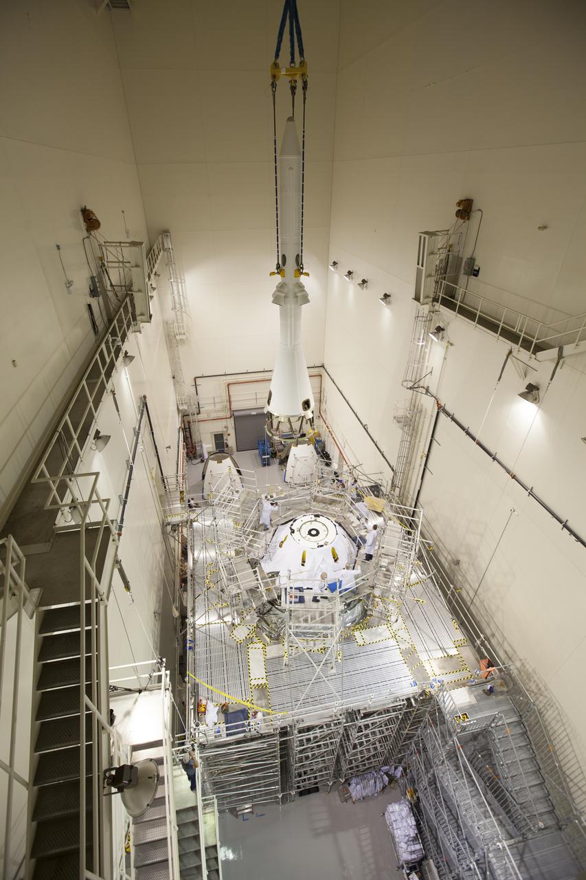 A crane is used to move the launch abort system closer for installation on the Orion spacecraft for Exploration Flight Test-1 inside the Launch Abort System Facility, or LASF, at NASA's Kennedy Space Center in Florida. The completed crew and service modules will be tested and verified together with the launch abort system. Orion will remain inside the LASF until mid-November, when the United Launch Alliance Delta IV Heavy rocket is ready for integration with the spacecraft. Orion is the exploration spacecraft designed to carry astronauts to destinations not yet explored by humans, including an asteroid and Mars. It will have emergency abort capability, sustain the crew during space travel and provide safe re-entry from deep space return velocities. The first unpiloted test flight of the Orion is scheduled to launch in December atop the Delta IV Heavy rocket from Cape Canaveral Air Force Station in Florida to an altitude of 3,600 miles above the Earth's surface. The two-orbit, four-hour flight test will help engineers evaluate the systems critical to crew safety including the heat shield, parachute system and launch abort system.