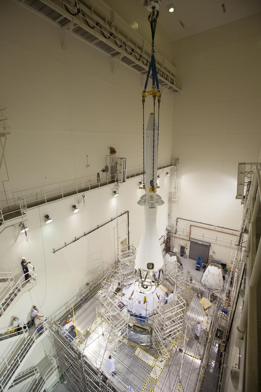 A crane is used to lower the launch abort system closer for installation on the Orion spacecraft for Exploration Flight Test-1 inside the Launch Abort System Facility, or LASF, at NASA's Kennedy Space Center in Florida. The completed crew and service modules will be tested and verified together with the launch abort system. Orion will remain inside the LASF until mid-November, when the United Launch Alliance Delta IV Heavy rocket is ready for integration with the spacecraft. Orion is the exploration spacecraft designed to carry astronauts to destinations not yet explored by humans, including an asteroid and Mars. It will have emergency abort capability, sustain the crew during space travel and provide safe re-entry from deep space return velocities. The first unpiloted test flight of the Orion is scheduled to launch in December atop the Delta IV Heavy rocket from Cape Canaveral Air Force Station in Florida to an altitude of 3,600 miles above the Earth's surface. The two-orbit, four-hour flight test will help engineers evaluate the systems critical to crew safety including the heat shield, parachute system and launch abort system.