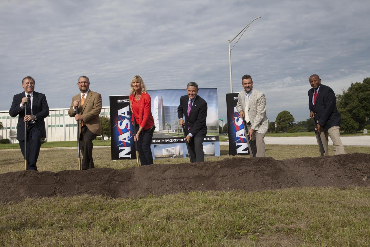 Groundbreaking for the new Central Campus took place in the Industrial Area at NASA's Kennedy Space Center in Florida. Digging in with shovels during the groundbreaking ceremony, are Dan Tweed, associate director for Facilities at Kennedy Steve Belflower, vice president of HuntonBrady Architects of Orlando Nancy Bray, director of Kennedy's Center Operations Directorate Kennedy Center Director Bob Cabana Kirk Hazen, southeast district manager and vice president of Hensel Phelps, the construction contractor and Kelvin Manning, Kennedy's associate director. Kennedy is transforming into a multi-user, 21st century spaceport supporting both commercial and government users and operations. Central Campus Phase I includes construction of a new Headquarters Building as one of the major components of the strategy. The new Headquarters Building will be a seven-story, 200,000-square-foot facility that will house about 500 NASA civil service and contractor employees. 