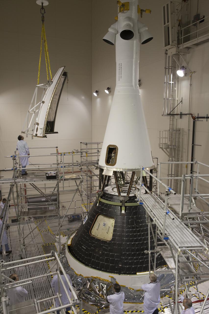 The first of four Ogive panels is lifted by crane for installation on Orion's Launch Abort System inside the Launch Abort System Facility at NASA’s Kennedy Space Center in Florida. The panels will smooth the airflow over the conical spacecraft to limit sound and vibration, which will make for a much smoother ride for the astronauts who will ride inside Orion in the future. The work marked the final major assembly steps for the spacecraft before it is transported to Space Launch Complex 37 at Cape Canaveral Air Force Station in November. Orion is the exploration spacecraft designed to carry astronauts to destinations not yet explored by humans, including an asteroid and Mars. It will have emergency abort capability, sustain the crew during space travel and provide safe re-entry from deep space return velocities. The first unpiloted flight test of Orion is scheduled to launch in December 2014 atop a United Launch Alliance Delta IV Heavy rocket, and in 2018 on NASA’s Space Launch System rocket.