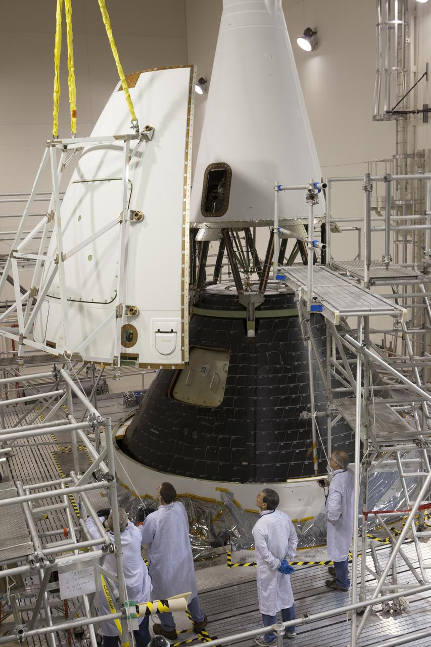 Inside the Launch Abort System Facility at NASA’s Kennedy Space Center in Florida, technicians monitor the progress as a crane moves the first of four Ogive panels closer for installation on Orion's Launch Abort System. The panels will smooth the airflow over the conical spacecraft to limit sound and vibration, which will make for a much smoother ride for the astronauts who will ride inside Orion in the future. The work marked the final major assembly steps for the spacecraft before it is transported to Space Launch Complex 37 at Cape Canaveral Air Force Station in November. Orion is the exploration spacecraft designed to carry astronauts to destinations not yet explored by humans, including an asteroid and Mars. It will have emergency abort capability, sustain the crew during space travel and provide safe re-entry from deep space return velocities. The first unpiloted flight test of Orion is scheduled to launch in December 2014 atop a United Launch Alliance Delta IV Heavy rocket, and in 2018 on NASA’s Space Launch System rocket.