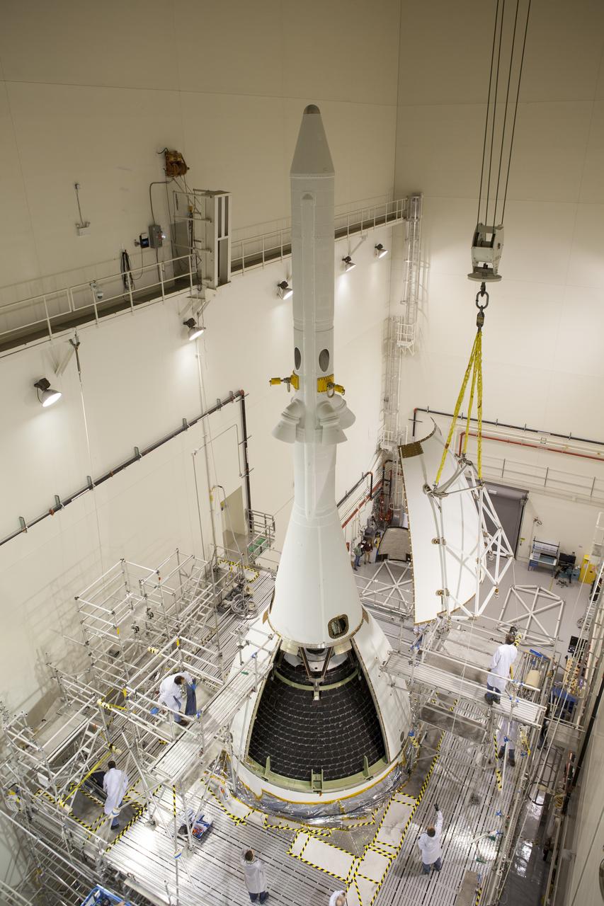 Inside the Launch Abort System Facility at NASA's Kennedy Space Center in Florida, a crane brings the third of four Ogive panels closer for installation on Orion's Launch Abort System. The panels will smooth the airflow over the conical spacecraft to limit sound and vibration, which will make for a much smoother ride for the astronauts who will ride inside Orion in the future. The work marked the final major assembly steps for the spacecraft before it is transported to Space Launch Complex 37 at Cape Canaveral Air Force Station in November. Orion is the exploration spacecraft designed to carry astronauts to destinations not yet explored by humans, including an asteroid and Mars. It will have emergency abort capability, sustain the crew during space travel and provide safe re-entry from deep space return velocities. The first unpiloted flight test of Orion is scheduled to launch in December 2014 atop a United Launch Alliance Delta IV Heavy rocket, and in 2018 on NASA’s Space Launch System rocket.