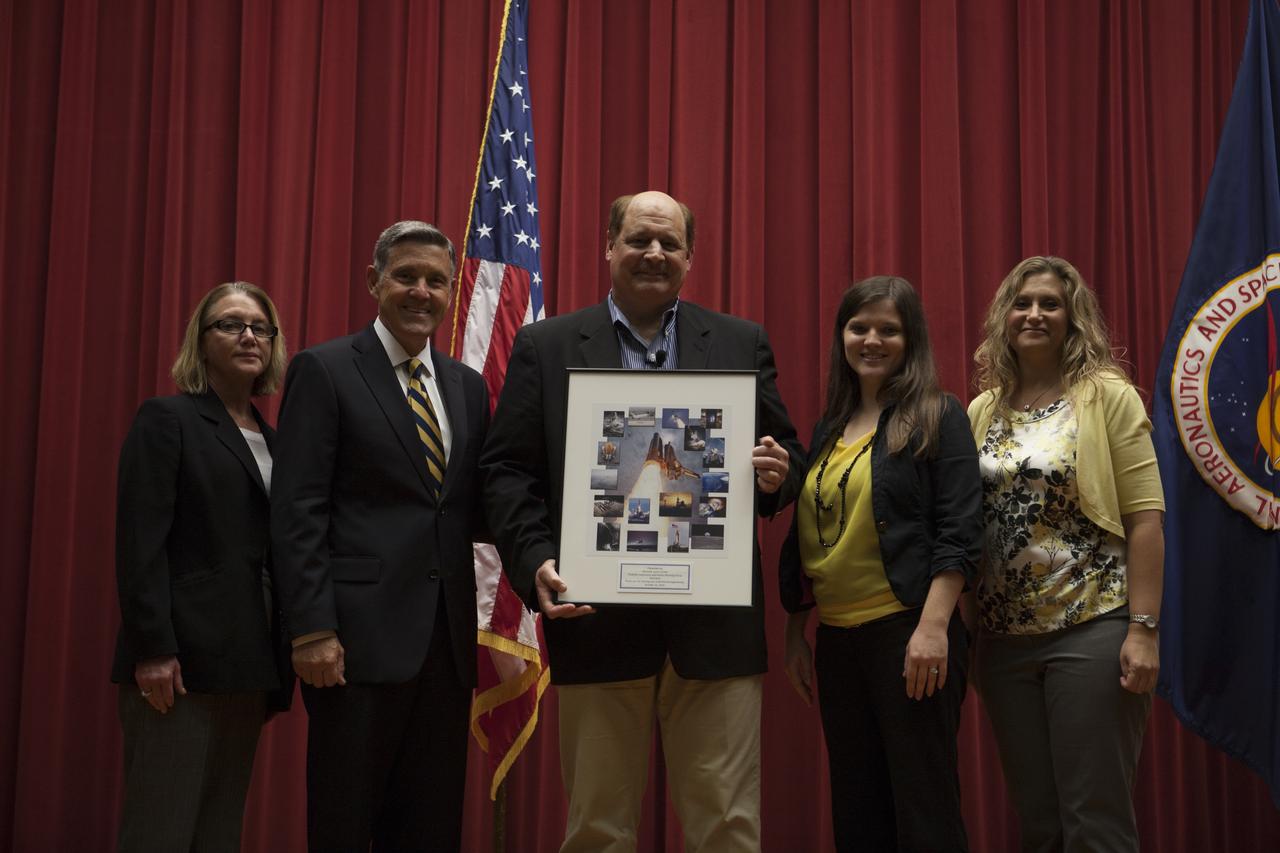Michael Kersjes, center, author and former special education teacher and football coach from Michigan, accepts a special plaque after his presentation to workers during the Disability Awareness and Action Working Group, or DAAWG, event at NASA's Kennedy Space Center in Florida. From left, are Susan Kroskey, Kennedy's chief financial officer and executive champion of DAAWG, Center Director Bob Cabana, and Jessica Conner and Nicole DelVesco, DAAWG co-chairpersons. The theme of Kersjes' presentation was "Power of the Human Spirit." Kersjes is the author of the book, "A Smile as Big as the Moon," which told the true story of how he worked to get special education students into Space Camp, a competitive education program at the U.S. Space and Rocket Center in Huntsville, Alabama. His book was made into a movie in 2012.