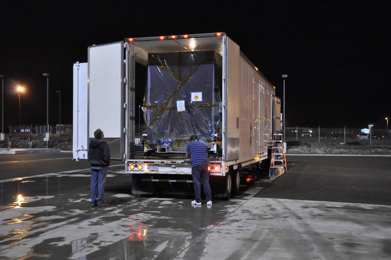 Workers prepare to offload NASA's Soil Moisture Active Passive, or SMAP, spacecraft from the truck that delivered it from the Jet Propulsion Laboratory in Pasadena, California, to the Astrotech payload processing facility on Vandenberg Air Force Base in California. SMAP will launch on a Delta II 7320 configuration vehicle featuring a United Launch Alliance first stage booster powered by an Aerojet Rocketdyne RS-27A main engine and three Alliant Techsystems, or ATK, strap-on solid rocket motors. Once on station in Earth orbit, SMAP will provide global measurements of soil moisture and its freeze/thaw state. These measurements will be used to enhance understanding of processes that link the water, energy and carbon cycles, and to extend the capabilities of weather and climate prediction models. SMAP data also will be used to quantify net carbon flux in boreal landscapes and to develop improved flood prediction and drought monitoring capabilities. Launch from Space Launch Complex 2 is targeted for Jan. 29, 2015.
