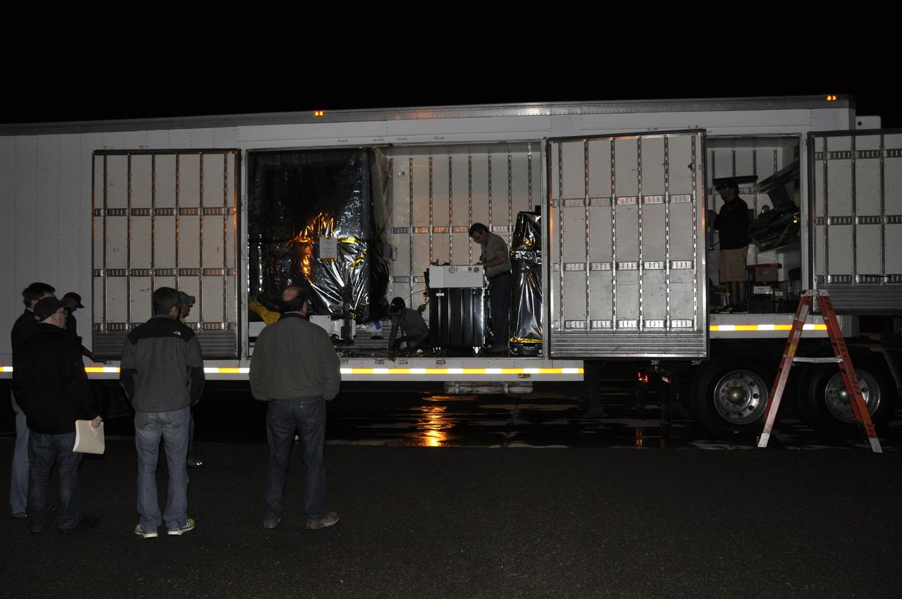 Workers are standing by to assist with the offloading of NASA's Soil Moisture Active Passive, or SMAP, spacecraft from the truck that delivered it from the Jet Propulsion Laboratory in Pasadena, California, to the Astrotech payload processing facility on Vandenberg Air Force Base in California. SMAP will launch on a Delta II 7320 configuration vehicle featuring a United Launch Alliance first stage booster powered by an Aerojet Rocketdyne RS-27A main engine and three Alliant Techsystems, or ATK, strap-on solid rocket motors. Once on station in Earth orbit, SMAP will provide global measurements of soil moisture and its freeze/thaw state. These measurements will be used to enhance understanding of processes that link the water, energy and carbon cycles, and to extend the capabilities of weather and climate prediction models. SMAP data also will be used to quantify net carbon flux in boreal landscapes and to develop improved flood prediction and drought monitoring capabilities. Launch from Space Launch Complex 2 is targeted for Jan. 29, 2015. 