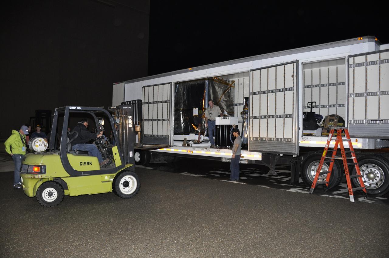 A forklift is moved into place to assist with the offloading of NASA's Soil Moisture Active Passive, or SMAP, spacecraft from the truck that delivered it from the Jet Propulsion Laboratory in Pasadena, California, to the Astrotech payload processing facility on Vandenberg Air Force Base in California. SMAP will launch on a Delta II 7320 configuration vehicle featuring a United Launch Alliance first stage booster powered by an Aerojet Rocketdyne RS-27A main engine and three Alliant Techsystems, or ATK, strap-on solid rocket motors. Once on station in Earth orbit, SMAP will provide global measurements of soil moisture and its freeze/thaw state. These measurements will be used to enhance understanding of processes that link the water, energy and carbon cycles, and to extend the capabilities of weather and climate prediction models. SMAP data also will be used to quantify net carbon flux in boreal landscapes and to develop improved flood prediction and drought monitoring capabilities. Launch from Space Launch Complex 2 is targeted for Jan. 29, 2015. 