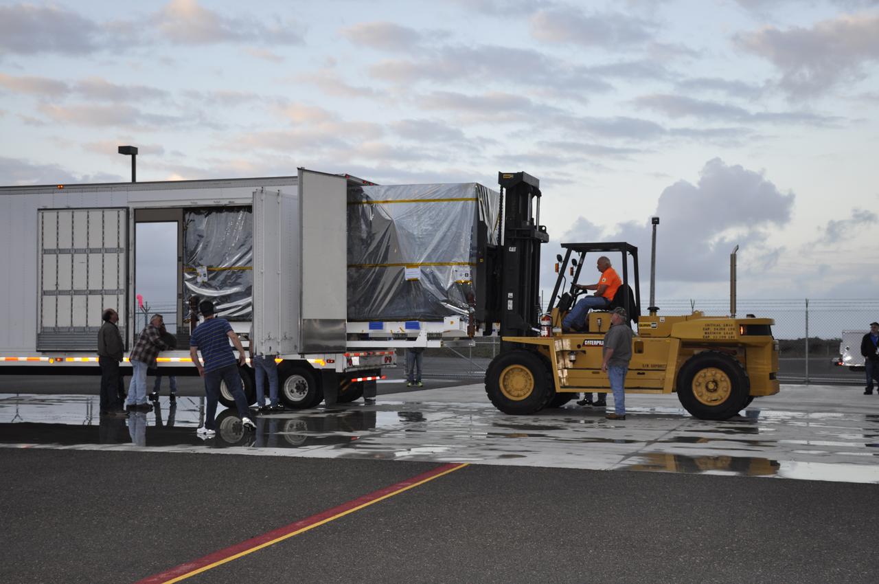 The transportation container protecting NASA's Soil Moisture Active Passive, or SMAP, spacecraft is offloaded from the truck that delivered it from the Jet Propulsion Laboratory in Pasadena, California, to the Astrotech payload processing facility on Vandenberg Air Force Base in California with the aid of a forklift. SMAP will launch on a Delta II 7320 configuration vehicle featuring a United Launch Alliance first stage booster powered by an Aerojet Rocketdyne RS-27A main engine and three Alliant Techsystems, or ATK, strap-on solid rocket motors. Once on station in Earth orbit, SMAP will provide global measurements of soil moisture and its freeze/thaw state. These measurements will be used to enhance understanding of processes that link the water, energy and carbon cycles, and to extend the capabilities of weather and climate prediction models. SMAP data also will be used to quantify net carbon flux in boreal landscapes and to develop improved flood prediction and drought monitoring capabilities. Launch from Space Launch Complex 2 is targeted for Jan. 29, 2015. 