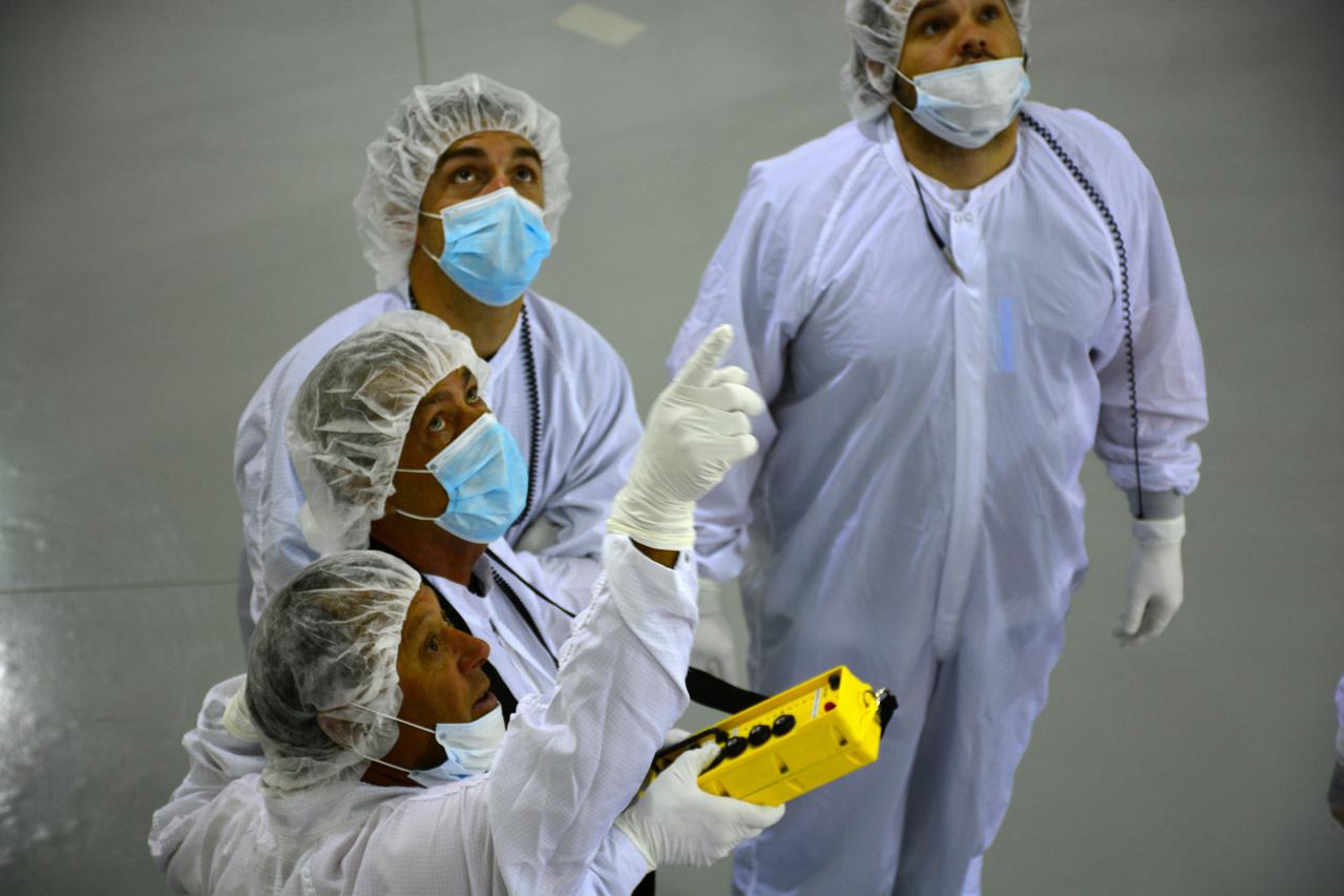 Inside the Astrotech payload processing facility on Vandenberg Air Force Base in California, engineers and technicians wearing protective garb, monitor operations as a crane lifts a component of NASA's Soil Moisture Active Passive, or SMAP, spacecraft. SMAP will launch on a Delta II 7320 configuration vehicle featuring a United Launch Alliance first stage booster powered by an Aerojet Rocketdyne RS-27A main engine and three Alliant Techsystems, or ATK, strap-on solid rocket motors. Once on station in Earth orbit, SMAP will provide global measurements of soil moisture and its freeze/thaw state. These measurements will be used to enhance understanding of processes that link the water, energy and carbon cycles, and to extend the capabilities of weather and climate prediction models. SMAP data also will be used to quantify net carbon flux in boreal landscapes and to develop improved flood prediction and drought monitoring capabilities. Launch from Space Launch Complex 2 is targeted for Jan. 29, 2015.