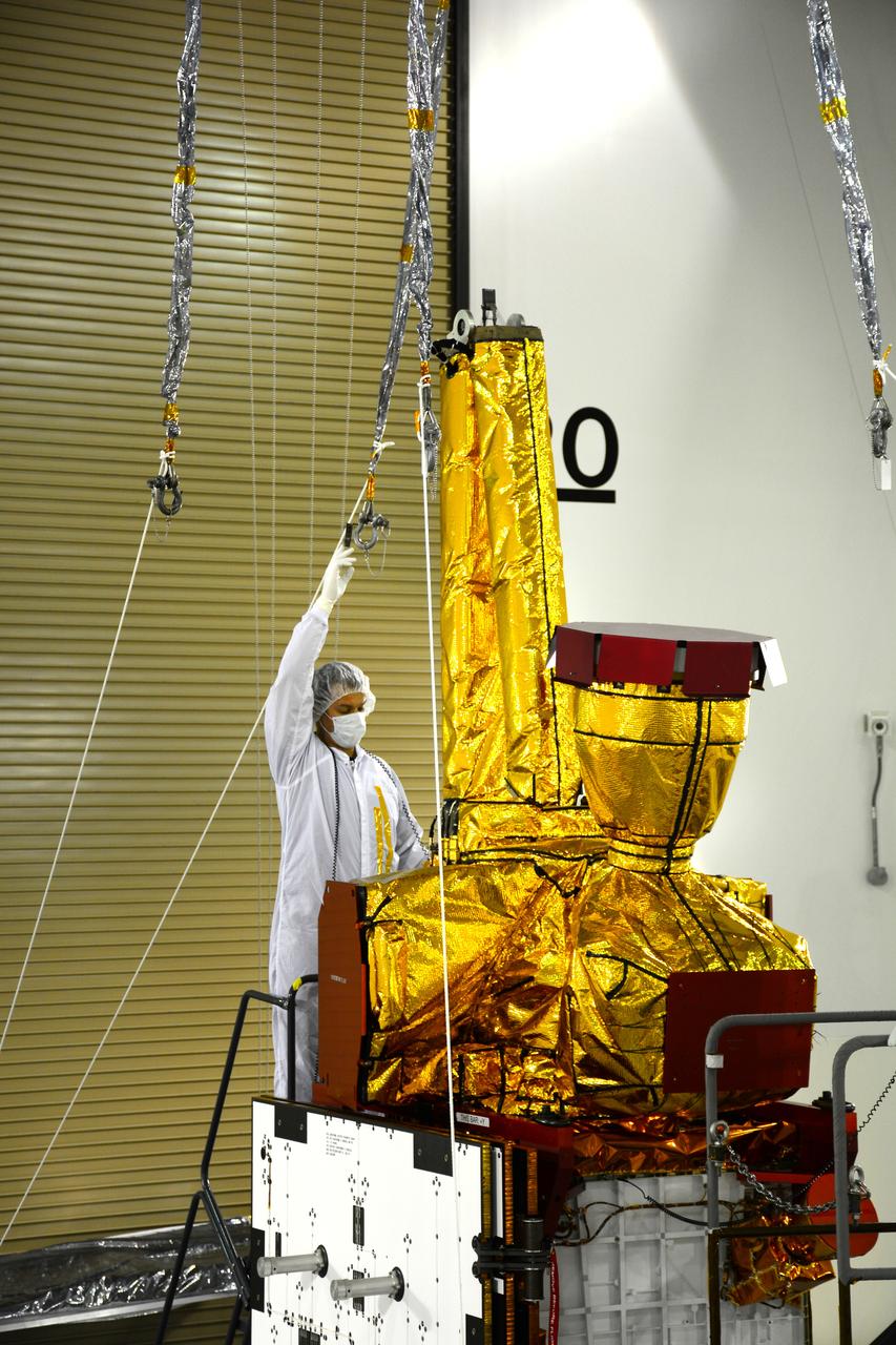 Inside the Astrotech payload processing facility on Vandenberg Air Force Base in California, an engineer inspects NASA's Soil Moisture Active Passive, or SMAP, spacecraft. SMAP will launch on a Delta II 7320 configuration vehicle featuring a United Launch Alliance first stage booster powered by an Aerojet Rocketdyne RS-27A main engine and three Alliant Techsystems, or ATK, strap-on solid rocket motors. Once on station in Earth orbit, SMAP will provide global measurements of soil moisture and its freeze/thaw state. These measurements will be used to enhance understanding of processes that link the water, energy and carbon cycles, and to extend the capabilities of weather and climate prediction models. SMAP data also will be used to quantify net carbon flux in boreal landscapes and to develop improved flood prediction and drought monitoring capabilities. Launch from Space Launch Complex 2 is targeted for Jan. 29, 2015.