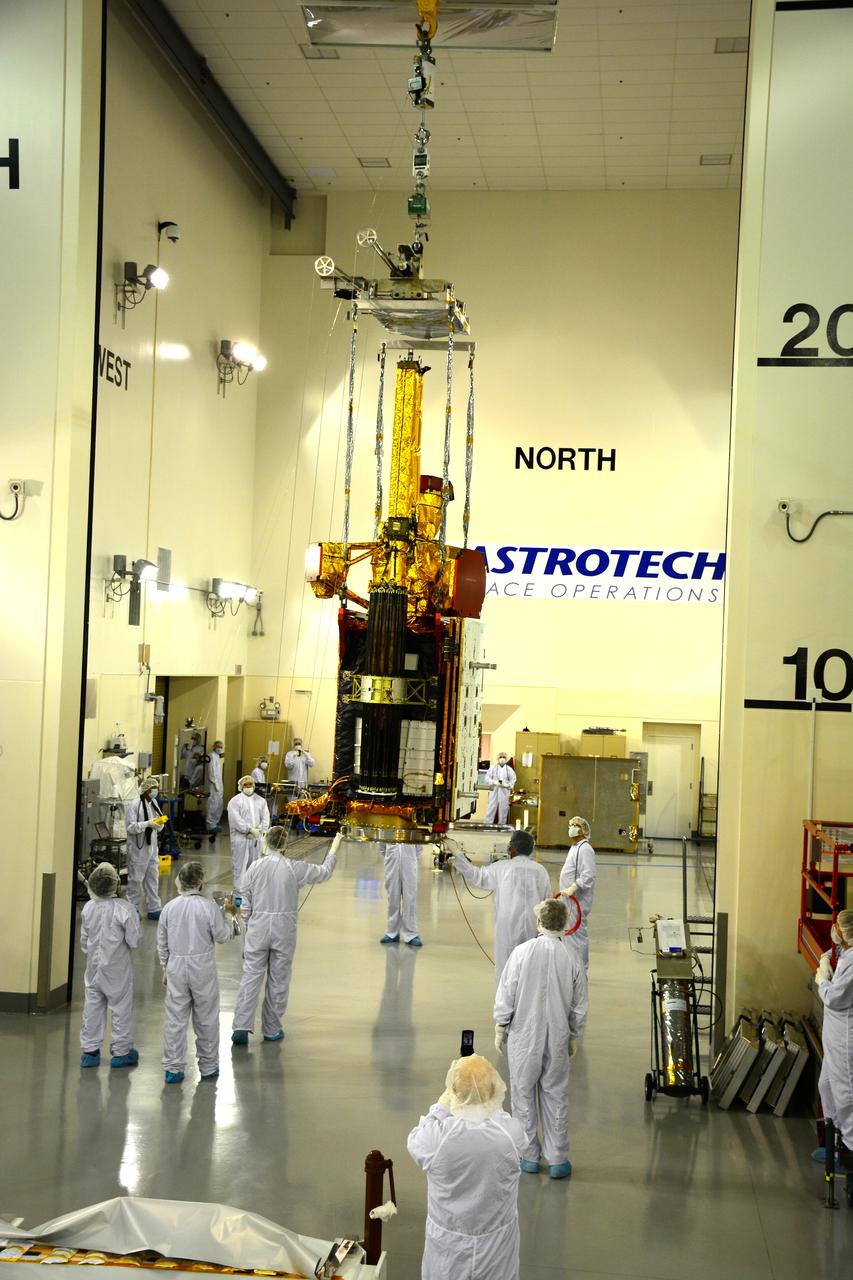 Inside the Astrotech payload processing facility on Vandenberg Air Force Base in California, engineers and technicians use a crane to move NASA's Soil Moisture Active Passive, or SMAP, spacecraft. SMAP will launch on a Delta II 7320 configuration vehicle featuring a United Launch Alliance first stage booster powered by an Aerojet Rocketdyne RS-27A main engine and three Alliant Techsystems, or ATK, strap-on solid rocket motors. Once on station in Earth orbit, SMAP will provide global measurements of soil moisture and its freeze/thaw state. These measurements will be used to enhance understanding of processes that link the water, energy and carbon cycles, and to extend the capabilities of weather and climate prediction models. SMAP data also will be used to quantify net carbon flux in boreal landscapes and to develop improved flood prediction and drought monitoring capabilities. Launch from Space Launch Complex 2 is targeted for Jan. 29, 2015.