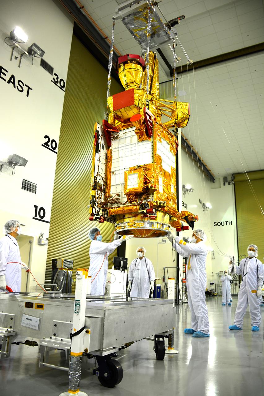 Inside the Astrotech payload processing facility on Vandenberg Air Force Base in California, engineers and technicians use a crane to move NASA's Soil Moisture Active Passive, or SMAP, spacecraft. SMAP will launch on a Delta II 7320 configuration vehicle featuring a United Launch Alliance first stage booster powered by an Aerojet Rocketdyne RS-27A main engine and three Alliant Techsystems, or ATK, strap-on solid rocket motors. Once on station in Earth orbit, SMAP will provide global measurements of soil moisture and its freeze/thaw state. These measurements will be used to enhance understanding of processes that link the water, energy and carbon cycles, and to extend the capabilities of weather and climate prediction models. SMAP data also will be used to quantify net carbon flux in boreal landscapes and to develop improved flood prediction and drought monitoring capabilities. Launch from Space Launch Complex 2 is targeted for Jan. 29, 2015.