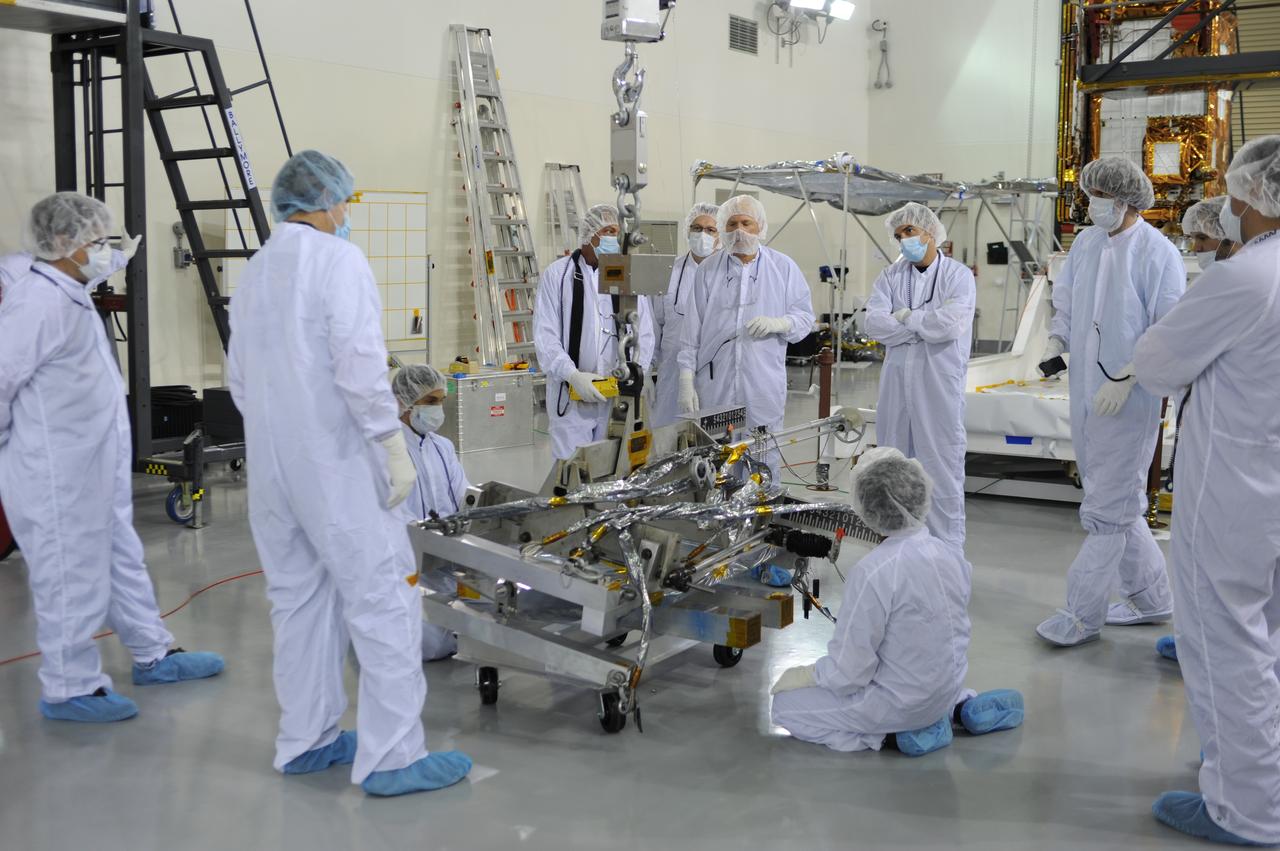 Inside the Astrotech payload processing facility on Vandenberg Air Force Base in California, engineers and technicians prepare a component of NASA's Soil Moisture Active Passive, or SMAP, spacecraft for a lift by a crane. SMAP will launch on a Delta II 7320 configuration vehicle featuring a United Launch Alliance first stage booster powered by an Aerojet Rocketdyne RS-27A main engine and three Alliant Techsystems, or ATK, strap-on solid rocket motors. Once on station in Earth orbit, SMAP will provide global measurements of soil moisture and its freeze/thaw state. These measurements will be used to enhance understanding of processes that link the water, energy and carbon cycles, and to extend the capabilities of weather and climate prediction models. SMAP data also will be used to quantify net carbon flux in boreal landscapes and to develop improved flood prediction and drought monitoring capabilities. Launch from Space Launch Complex 2 is targeted for Jan. 29, 2015. 