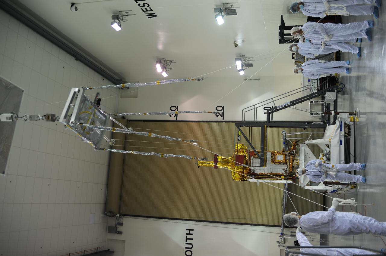 Inside the Astrotech payload processing facility on Vandenberg Air Force Base in California, engineers and technicians use a crane to move a component of NASA's Soil Moisture Active Passive, or SMAP, spacecraft for a lift by a crane. SMAP will launch on a Delta II 7320 configuration vehicle featuring a United Launch Alliance first stage booster powered by an Aerojet Rocketdyne RS-27A main engine and three Alliant Techsystems, or ATK, strap-on solid rocket motors. Once on station in Earth orbit, SMAP will provide global measurements of soil moisture and its freeze/thaw state. These measurements will be used to enhance understanding of processes that link the water, energy and carbon cycles, and to extend the capabilities of weather and climate prediction models. SMAP data also will be used to quantify net carbon flux in boreal landscapes and to develop improved flood prediction and drought monitoring capabilities. Launch from Space Launch Complex 2 is targeted for Jan. 29, 2015. 