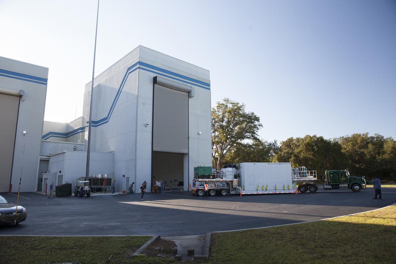 The airlock door opens at Building 2 of the Astrotech payload processing facility in Titusville, Florida, near Kennedy Space Center, for ingress of the protective shipping container enclosing the Magnetospheric Multiscale spacecraft. MMS is a Solar Terrestrial Probes mission comprising four identically instrumented spacecraft that will use Earth’s magnetosphere as a laboratory to study the microphysics of three fundamental plasma processes: magnetic reconnection, energetic particle acceleration and turbulence. Launch aboard a United Launch Alliance Atlas V rocket from Space Launch Complex 41 on Cape Canaveral Air Force Station is targeted for March 12, 2015. 