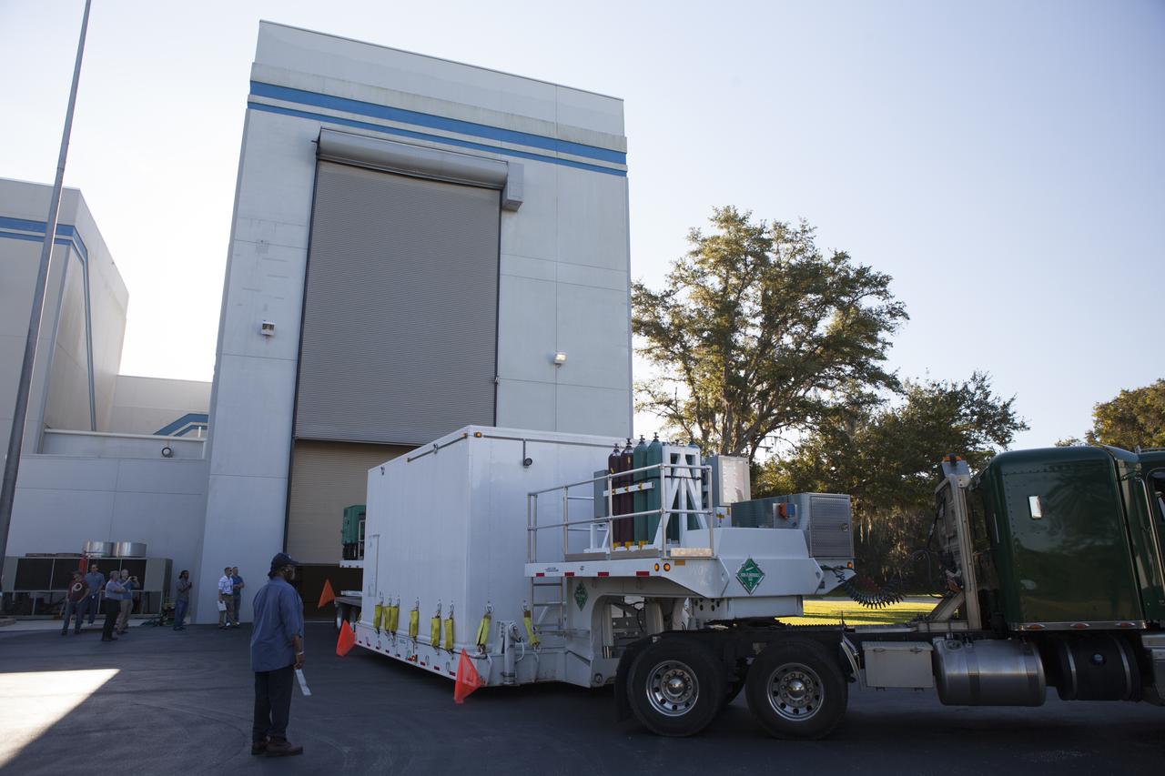 Operations are underway to move the protective shipping container enclosing the Magnetospheric Multiscale spacecraft into the airlock of Building 2 at the Astrotech payload processing facility in Titusville, Florida, near Kennedy Space Center. MMS is a Solar Terrestrial Probes mission comprising four identically instrumented spacecraft that will use Earth’s magnetosphere as a laboratory to study the microphysics of three fundamental plasma processes: magnetic reconnection, energetic particle acceleration and turbulence. Launch aboard a United Launch Alliance Atlas V rocket from Space Launch Complex 41 on Cape Canaveral Air Force Station is targeted for March 12, 2015.