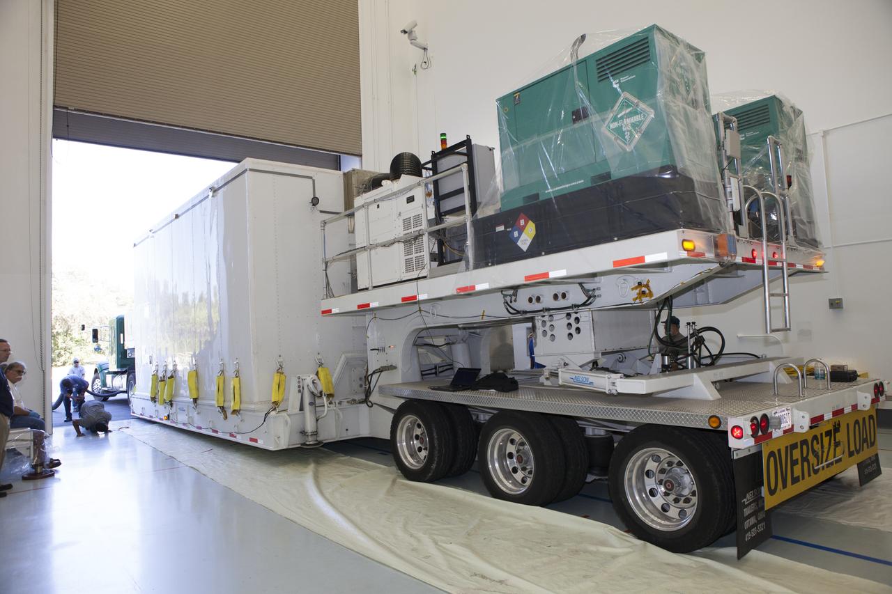 Preparations are underway to remove the lower stack, mini-stack number 1, two of the observatories for NASA's Magnetospheric Multiscale Observatory, or MMS, from their protective shipping container in the Building 2 south encapsulation bay at the Astrotech payload processing facility in Titusville, Florida, near Kennedy Space Center. The MMS upper stack, mini-stack number 2, is scheduled to arrive in about two weeks. MMS is a Solar Terrestrial Probes mission comprising four identically instrumented spacecraft that will use Earth’s magnetosphere as a laboratory to study the microphysics of three fundamental plasma processes: magnetic reconnection, energetic particle acceleration and turbulence. Launch aboard a United Launch Alliance Atlas V rocket from Space Launch Complex 41 on Cape Canaveral Air Force Station is targeted for March 12, 2015. 
