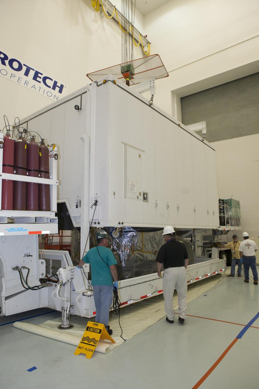 The protective shipping container is lifted from the lower stack, mini-stack number 1, two of the observatories for NASA's Magnetospheric Multiscale Observatory, or MMS, in the Building 2 south encapsulation bay at the Astrotech payload processing facility in Titusville, Florida, near Kennedy Space Center. The MMS upper stack, mini-stack number 2, is scheduled to arrive in about two weeks. MMS is a Solar Terrestrial Probes mission comprising four identically instrumented spacecraft that will use Earth’s magnetosphere as a laboratory to study the microphysics of three fundamental plasma processes: magnetic reconnection, energetic particle acceleration and turbulence. Launch aboard a United Launch Alliance Atlas V rocket from Space Launch Complex 41 on Cape Canaveral Air Force Station is targeted for March 12, 2015.