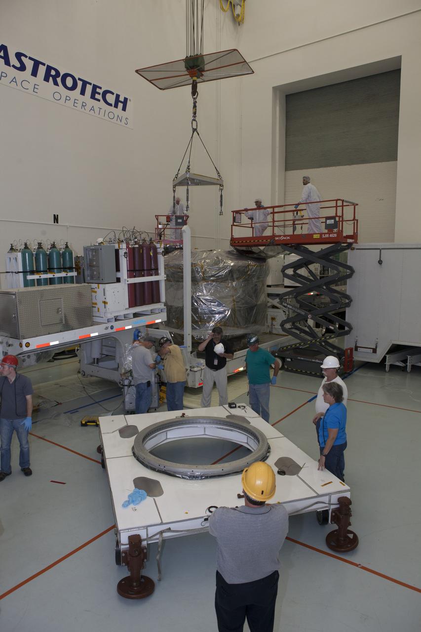 A crane is lowered toward the lower stack, mini-stack number 1, two of the observatories for NASA's Magnetospheric Multiscale Observatory, or MMS, during uncrating operations in the Building 2 south encapsulation bay at the Astrotech payload processing facility in Titusville, Florida, near Kennedy Space Center. The MMS upper stack, mini-stack number 2, is scheduled to arrive in about two weeks. MMS is a Solar Terrestrial Probes mission comprising four identically instrumented spacecraft that will use Earth’s magnetosphere as a laboratory to study the microphysics of three fundamental plasma processes: magnetic reconnection, energetic particle acceleration and turbulence. Launch aboard a United Launch Alliance Atlas V rocket from Space Launch Complex 41 on Cape Canaveral Air Force Station is targeted for March 12, 2015.