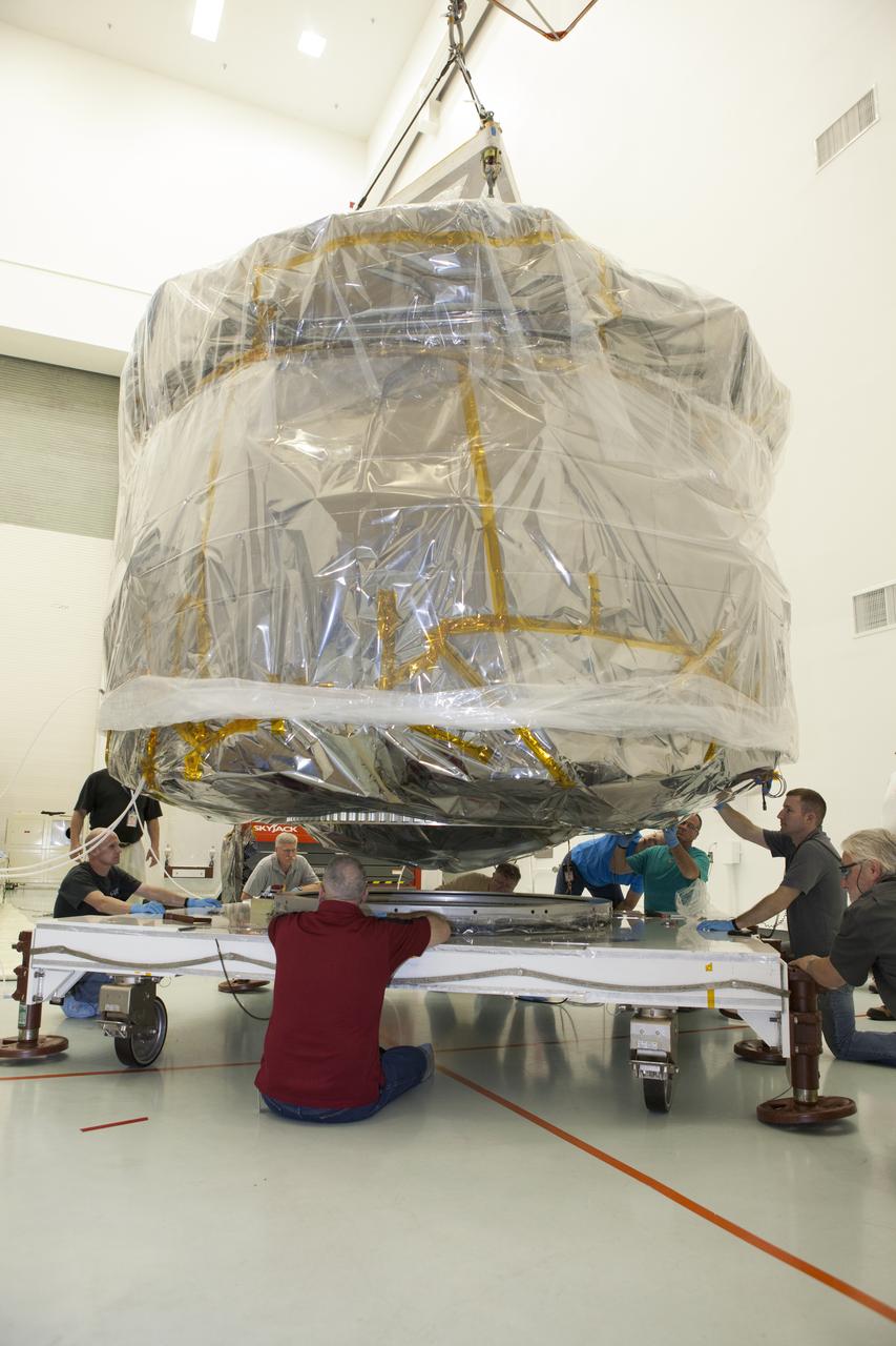 Workers position two of the observatories, the lower stack, mini-stack number 1 for NASA's Magnetospheric Multiscale Observatory, or MMS, onto a payload dolly in the Building 2 south encapsulation bay at the Astrotech payload processing facility in Titusville, Florida, near Kennedy Space Center. The MMS upper stack, mini-stack number 2, is scheduled to arrive in about two weeks. MMS is a Solar Terrestrial Probes mission comprising four identically instrumented spacecraft that will use Earth’s magnetosphere as a laboratory to study the microphysics of three fundamental plasma processes: magnetic reconnection, energetic particle acceleration and turbulence. Launch aboard a United Launch Alliance Atlas V rocket from Space Launch Complex 41 on Cape Canaveral Air Force Station is targeted for March 12, 2015.