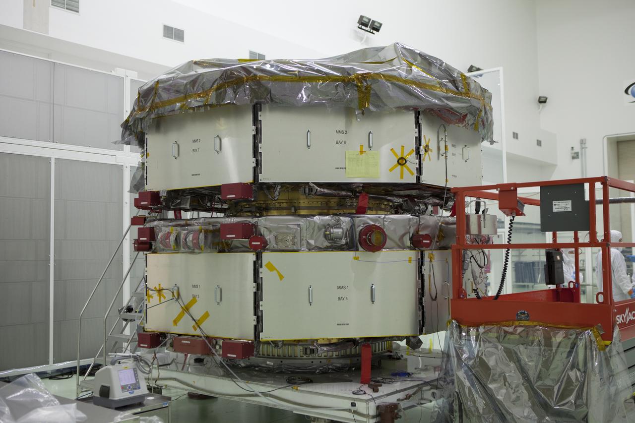 Most of the protective covering has been removed from the lower stack, mini-stack number 1, two of the observatories for NASA's Magnetospheric Multiscale Observatory, or MMS, inside Building 1 D high bay at the Astrotech payload processing facility in Titusville, Florida, near Kennedy Space Center. The MMS upper stack, mini-stack number 2, is scheduled to arrive in about two weeks. MMS is a Solar Terrestrial Probes mission comprising four identically instrumented spacecraft that will use Earth’s magnetosphere as a laboratory to study the microphysics of three fundamental plasma processes: magnetic reconnection, energetic particle acceleration and turbulence. Launch aboard a United Launch Alliance Atlas V rocket from Space Launch Complex 41 on Cape Canaveral Air Force Station is targeted for March 12, 2015.