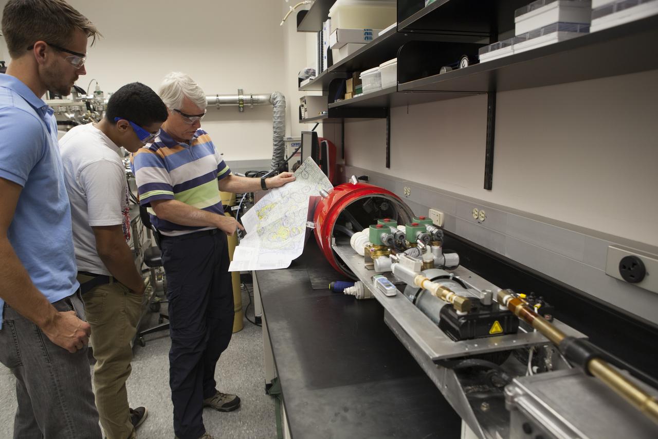 Researchers at NASA’s Kennedy Space Center in Florida check readings on the Dust Atmospheric Recovery Technology, or DART, spacecraft inside a laboratory at the Space Life Sciences Lab. DART will characterize the dust loading and microbial diversity in the atmosphere over Florida during summer months with a special emphasis on their interactions during an African dust storm. DART will be used to collect atmospheric aerosols and suspended microbial cells over Florida and Kennedy. Results will help predict the risks of excessive microbial contamination adhering to spacecraft surfaces. 