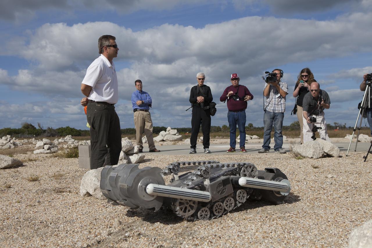 Rob Mueller, NASA senior technologist in the Surface Systems Office in Kennedy Space Center's Engineering and Technology Directorate, demonstrates the Regolith Advanced Surface System Operations Robot, or RASSOR, during a media event at Kennedy's automated landing and hazard avoidance technology, or ALHAT, hazard field at the north end of the Shuttle Landing Facility. The event was held to announce Moon Express Inc., of Moffett Field, California is selected to utilize Kennedy facilities for NASA's Lunar Cargo Transportation and Landing by Soft Touchdown, or Lunar CATALYST, initiative. Moon Express is developing a lander with capabilities that will enable delivery of payloads to the surface of the moon, as well as new science and exploration missions of interest to NASA and scientific and academic communities. Moon Express will base its activities at Kennedy and utilize the Morpheus ALHAT field and a hangar nearby for CATALYST testing. The Advanced Exploration Systems Division of NASA's Human Exploration and Operations Mission Directorate manages Lunar CATALYST.