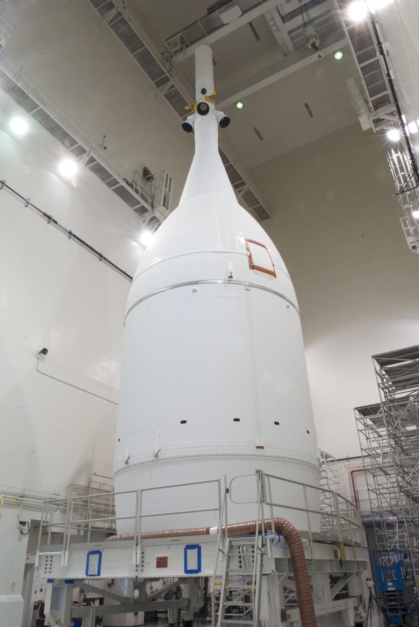 The Orion spacecraft sits inside the Launch Abort System Facility at NASA's Kennedy Space Center in Florida. The Ogive panels have been installed around the launch abort system. The panels will smooth the airflow over the conical spacecraft to limit sound and vibration, which will make for a much smoother ride for the astronauts who will ride inside Orion in the future. The spacecraft is being readied for its move to Space Launch Complex 37 at Cape Canaveral Air Force Station for its flight test. Orion is the exploration spacecraft designed to carry astronauts to destinations not yet explored by humans, including an asteroid and Mars. It will have emergency abort capability, sustain the crew during space travel and provide safe re-entry from deep space return velocities. The first unpiloted flight test of Orion is scheduled to launch in December 2014 atop a United Launch Alliance Delta IV Heavy rocket, and in 2018 on NASA’s Space Launch System rocket. 