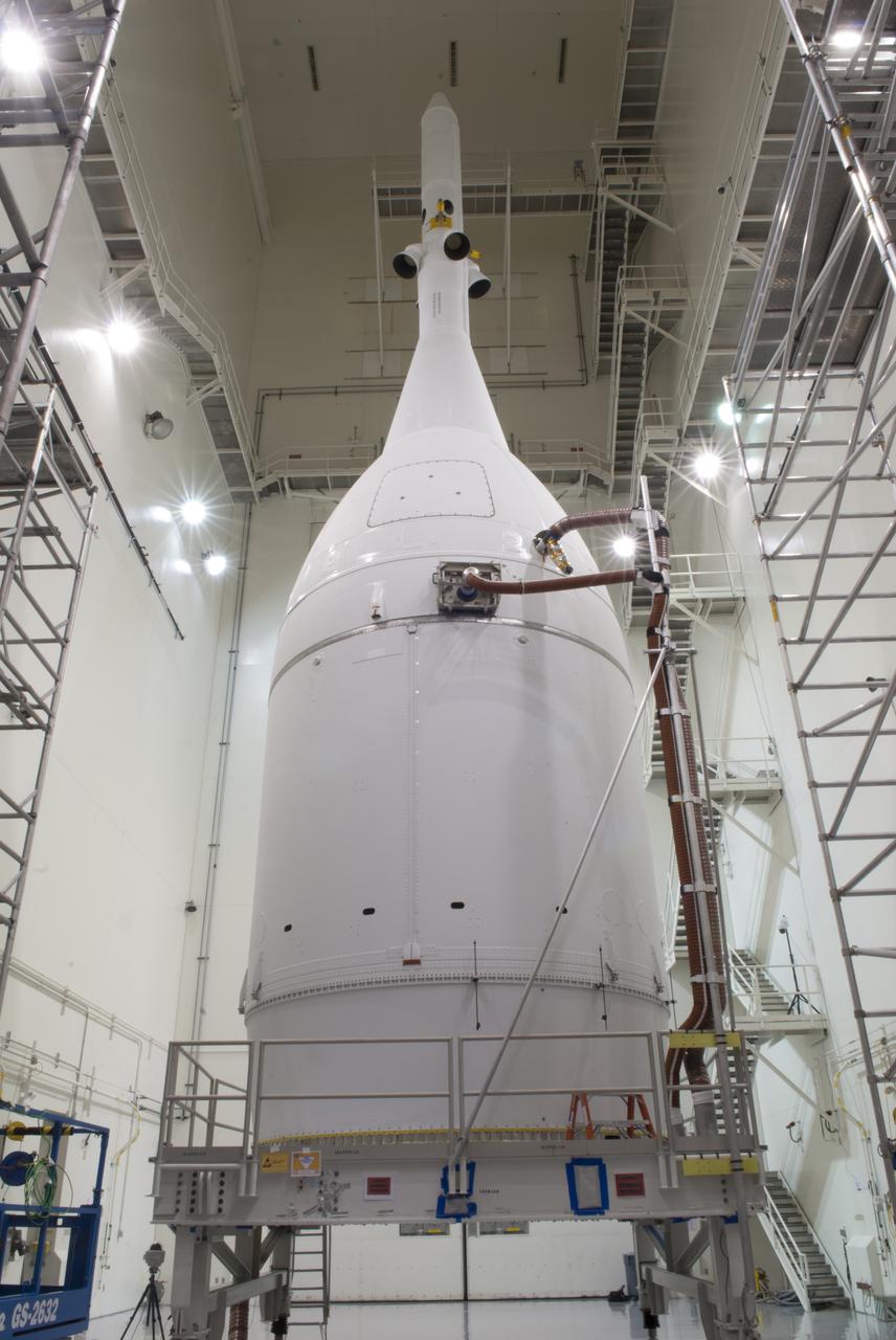 The Orion spacecraft sits inside the Launch Abort System Facility at NASA's Kennedy Space Center in Florida. The Ogive panels have been installed around the launch abort system. The panels will smooth the airflow over the conical spacecraft to limit sound and vibration, which will make for a much smoother ride for the astronauts who will ride inside Orion in the future. The spacecraft is being readied for its move to Space Launch Complex 37 at Cape Canaveral Air Force Station for its flight test. Orion is the exploration spacecraft designed to carry astronauts to destinations not yet explored by humans, including an asteroid and Mars. It will have emergency abort capability, sustain the crew during space travel and provide safe re-entry from deep space return velocities. The first unpiloted flight test of Orion is scheduled to launch in December 2014 atop a United Launch Alliance Delta IV Heavy rocket, and in 2018 on NASA’s Space Launch System rocket. 