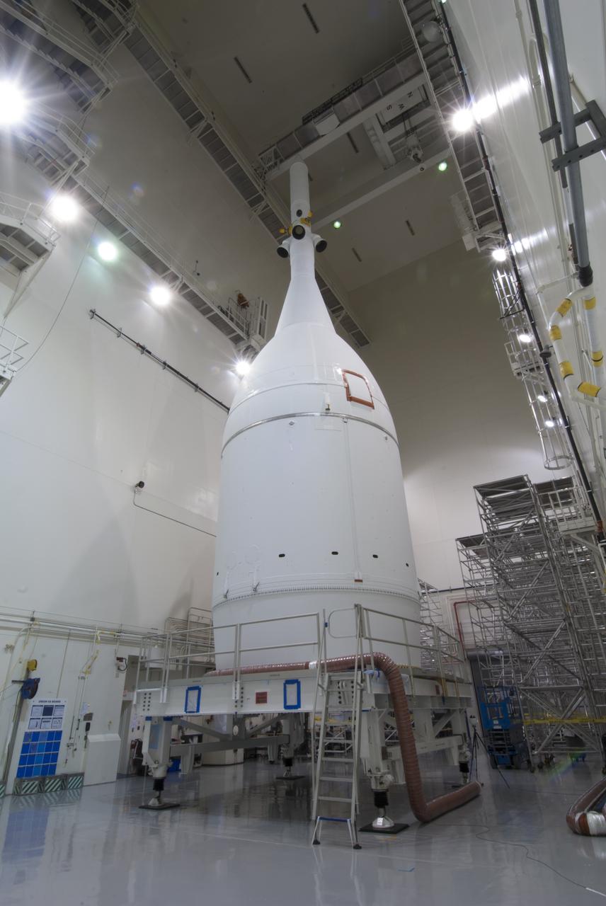 The Orion spacecraft sits inside the Launch Abort System Facility at NASA's Kennedy Space Center in Florida. The Ogive panels have been installed around the launch abort system. The panels will smooth the airflow over the conical spacecraft to limit sound and vibration, which will make for a much smoother ride for the astronauts who will ride inside Orion in the future. The spacecraft is being readied for its move to Space Launch Complex 37 at Cape Canaveral Air Force Station for its flight test. Orion is the exploration spacecraft designed to carry astronauts to destinations not yet explored by humans, including an asteroid and Mars. It will have emergency abort capability, sustain the crew during space travel and provide safe re-entry from deep space return velocities. The first unpiloted flight test of Orion is scheduled to launch in December 2014 atop a United Launch Alliance Delta IV Heavy rocket, and in 2018 on NASA’s Space Launch System rocket. 