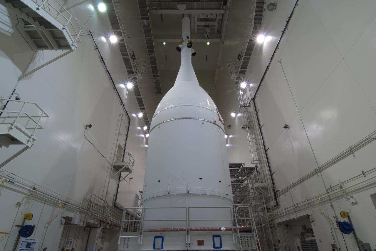 The Orion spacecraft sits inside the Launch Abort System Facility at NASA's Kennedy Space Center in Florida. The Ogive panels have been installed around the launch abort system. The panels will smooth the airflow over the conical spacecraft to limit sound and vibration, which will make for a much smoother ride for the astronauts who will ride inside Orion in the future. The spacecraft is being readied for its move to Space Launch Complex 37 at Cape Canaveral Air Force Station for its flight test. Orion is the exploration spacecraft designed to carry astronauts to destinations not yet explored by humans, including an asteroid and Mars. It will have emergency abort capability, sustain the crew during space travel and provide safe re-entry from deep space return velocities. The first unpiloted flight test of Orion is scheduled to launch in December 2014 atop a United Launch Alliance Delta IV Heavy rocket, and in 2018 on NASA’s Space Launch System rocket.