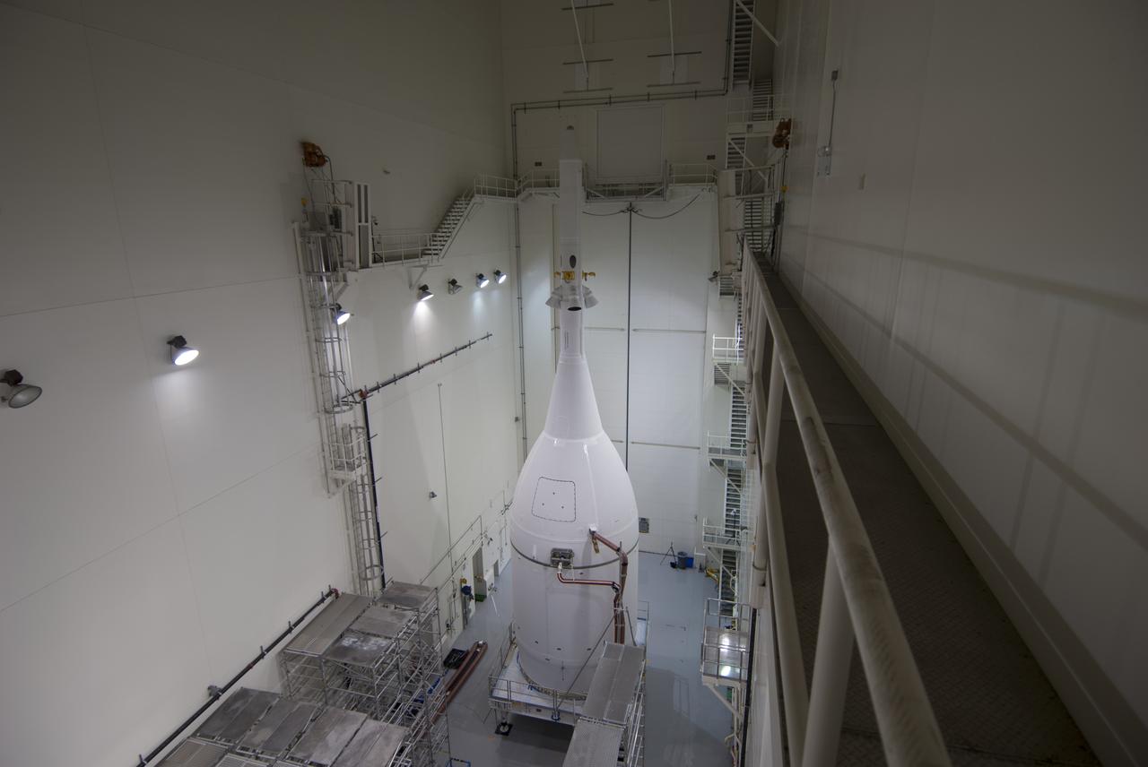 The Orion spacecraft sits inside the Launch Abort System Facility at NASA's Kennedy Space Center in Florida. The Ogive panels have been installed around the launch abort system. The panels will smooth the airflow over the conical spacecraft to limit sound and vibration, which will make for a much smoother ride for the astronauts who will ride inside Orion in the future. The spacecraft is being readied for its move to Space Launch Complex 37 at Cape Canaveral Air Force Station for its flight test. Orion is the exploration spacecraft designed to carry astronauts to destinations not yet explored by humans, including an asteroid and Mars. It will have emergency abort capability, sustain the crew during space travel and provide safe re-entry from deep space return velocities. The first unpiloted flight test of Orion is scheduled to launch in December 2014 atop a United Launch Alliance Delta IV Heavy rocket, and in 2018 on NASA’s Space Launch System rocket. 