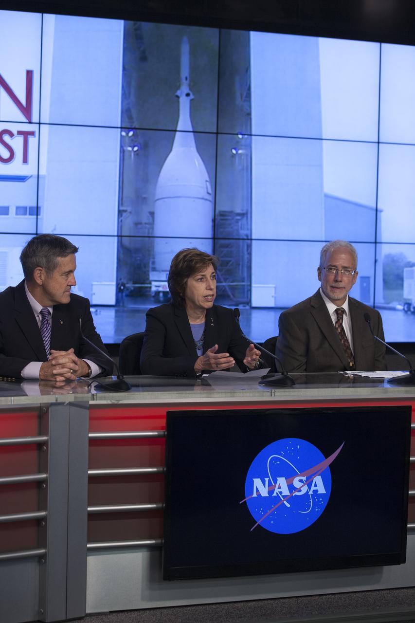 In the Kennedy Space Center’s Press Site auditorium, agency leaders spoke to members of the news media as the completed Orion spacecraft was being prepared for its trip from the Launch Abort System Facility to Launch Complex 37 at Cape Canaveral Air Force Station. From left are: Kennedy Director Bob Cabana, Johnson Space Center Director Ellen Ochoa, and NASA Orion Program manager Mark Geyer. Orion is the exploration spacecraft designed to carry astronauts to destinations not yet explored by humans, including an asteroid and Mars. It will have emergency abort capability, sustain the crew during space travel and provide safe re-entry from deep space return velocities. The first unpiloted flight test of Orion is scheduled to launch Dec. 4, 2014 atop a United Launch Alliance Delta IV Heavy rocket, and in 2018 on NASA’s Space Launch System rocket.